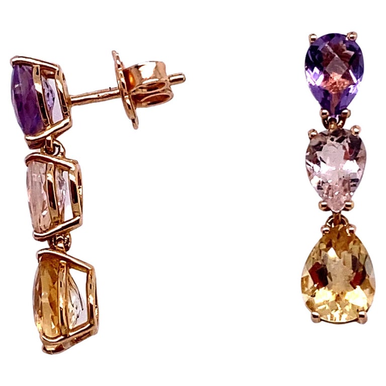 French Gold Earrings accompanied by 3 Stones an Amethyst a Beryl and a Citrine
The cut of the stones is Pear shaped.
The mount is articulated between each stone which gives movement to the pendant earrings. The lightness of this frame will make them
