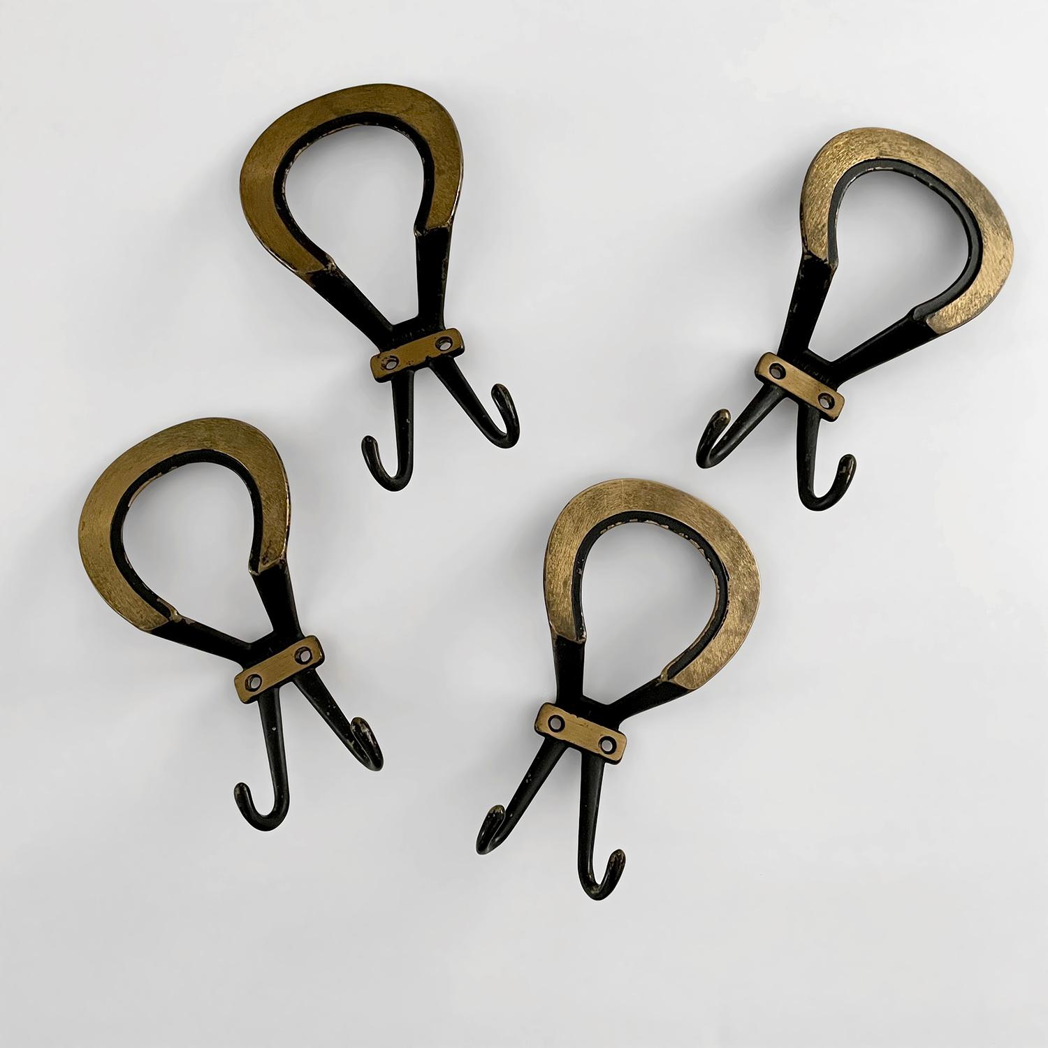 French gold leaf & iron loop hook
France, mid century
Beautifully contrasted iron with gold leaf accents creates a palette to please    
Each wall mounted hook is supported by a bracket which requires two screws
Upper portion is beautifully sculpted
