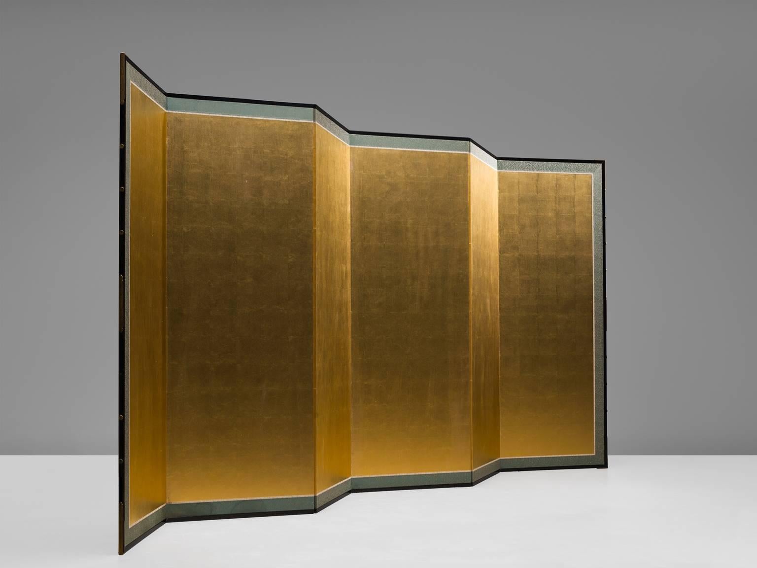 Room divider, gold leaf paper, cardboard, France, 1950s.

This splendid screen features a shimmering side with gold leaf and a side with a blue geometric decoration. The screen has three folding lines which is useful in order to place the divider