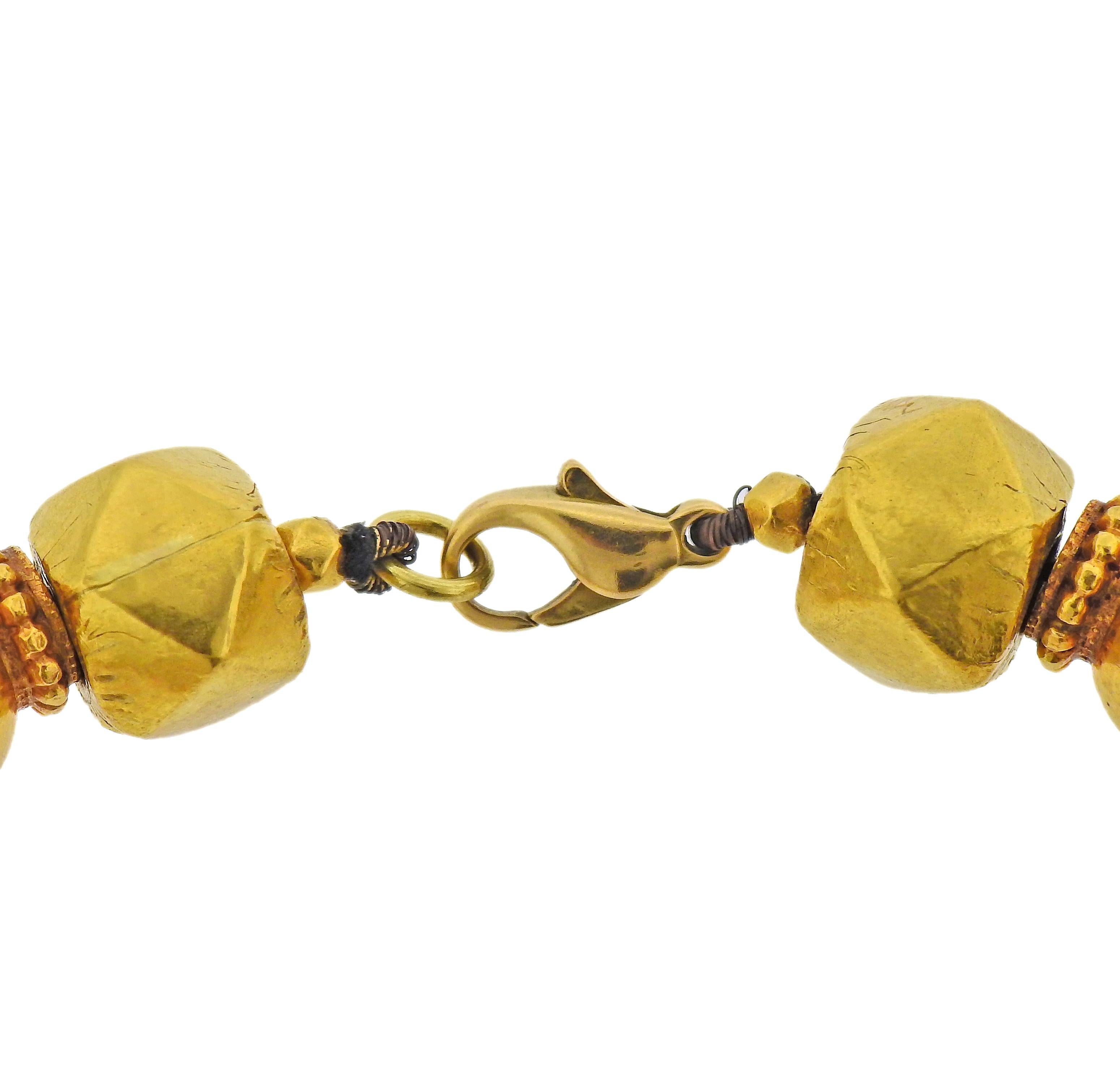 22k yellow gold geometric beads, suspended on a cord with French 18k gold clasp. Necklace is 17