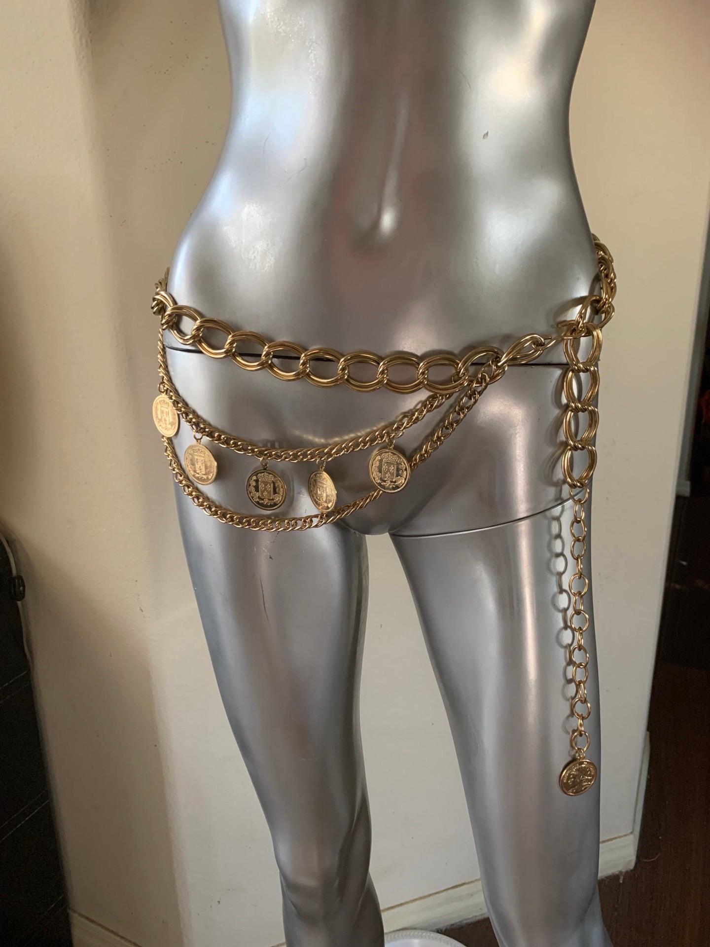 A beautiful chain belt purchased in NYC. Manufacturer unknown. Country of origin unknown. Faux French coins (doublesided) hand from shiny gold plated links and chains. Very, very chic. One size fits all. Plenty of length for all.