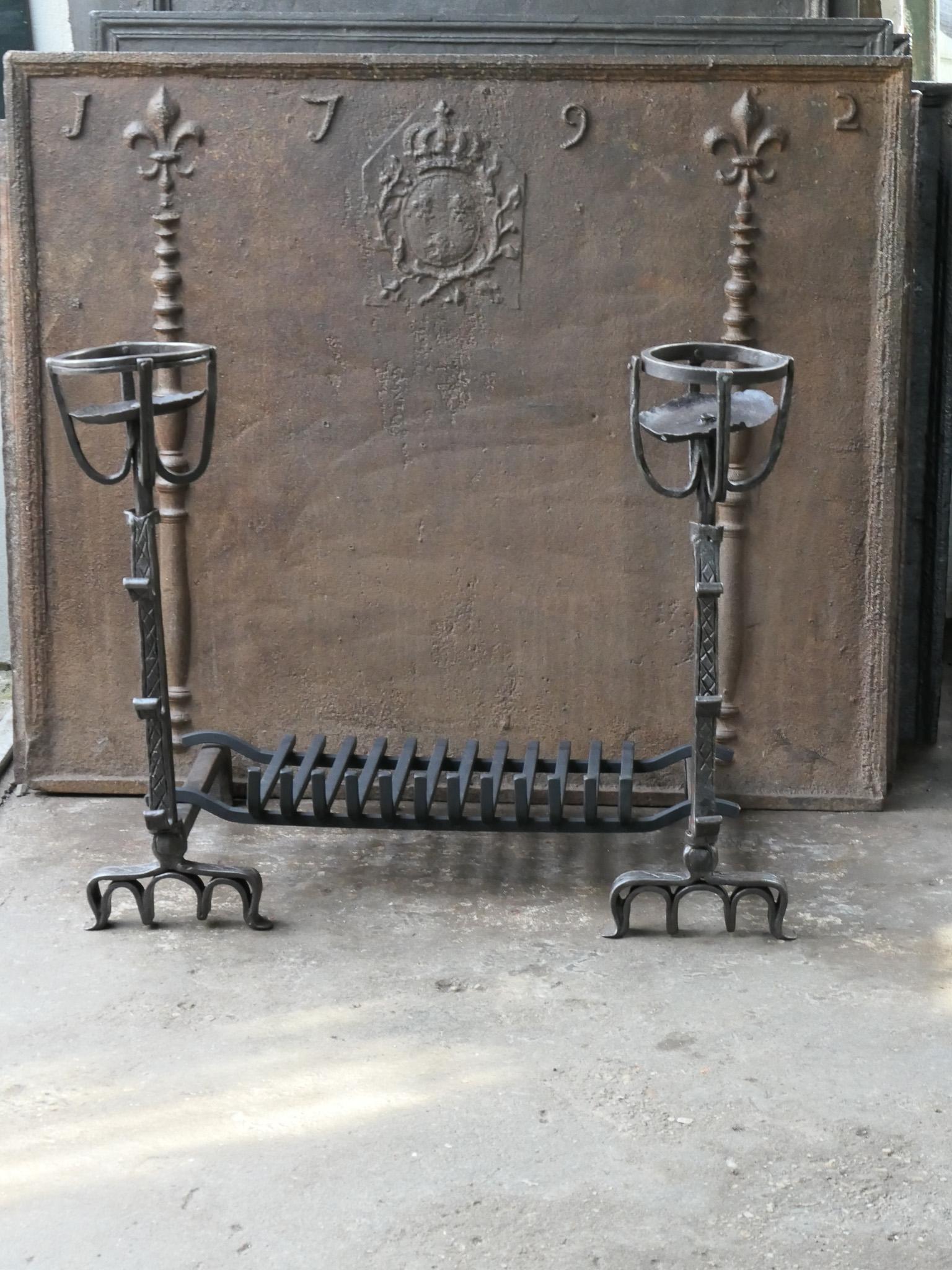 17th century French Gothic fire grate with period andirons and a recently forged grate. Made of wrought iron. The condition is good. 







