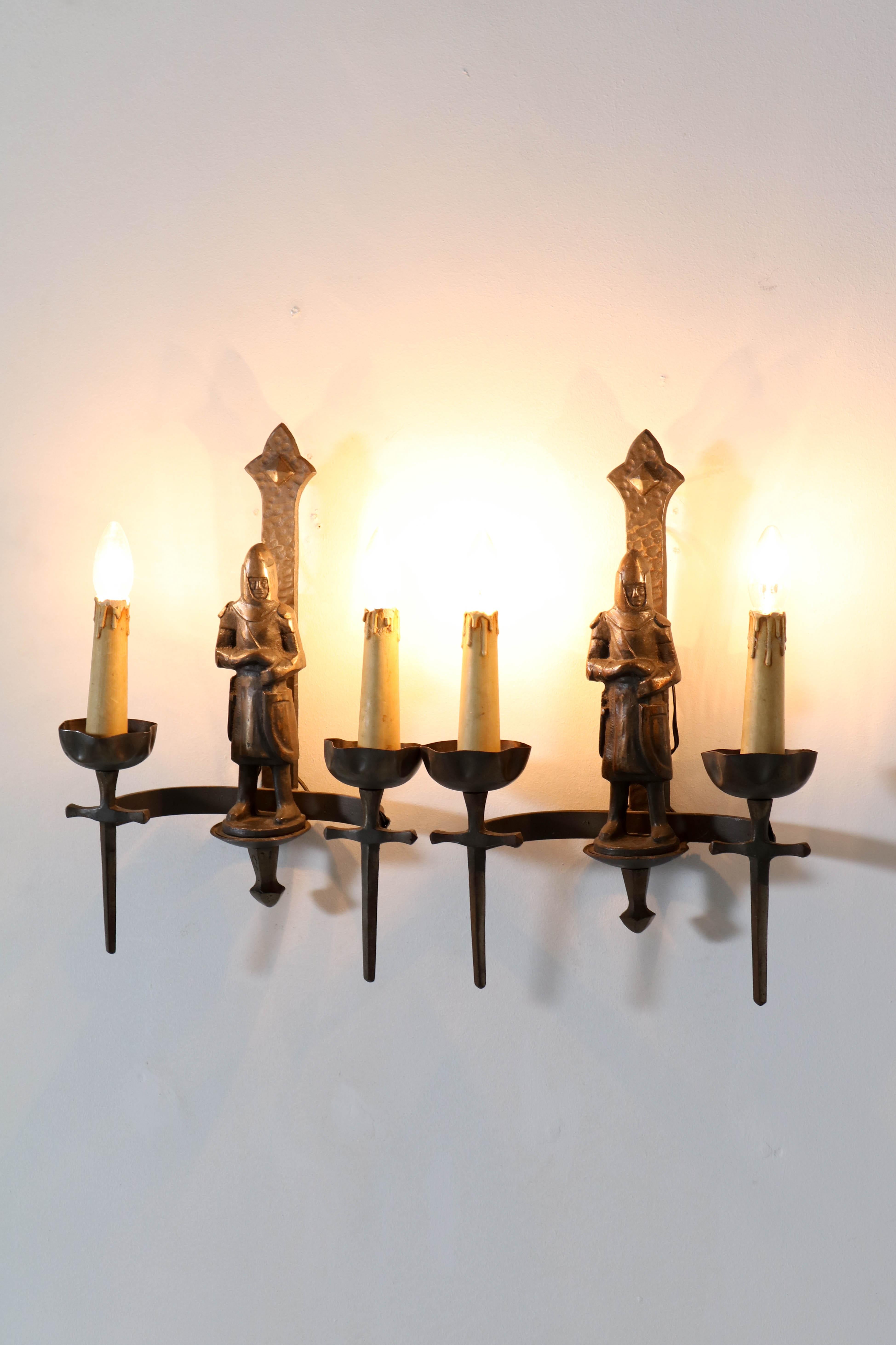 Wonderful and decorative pair of Gothic Revival wall lights or sconses.
Striking French design from the fifties.
Handcrafted with forged and cast iron elements.
In very good original condition with a beautiful bronze patina.