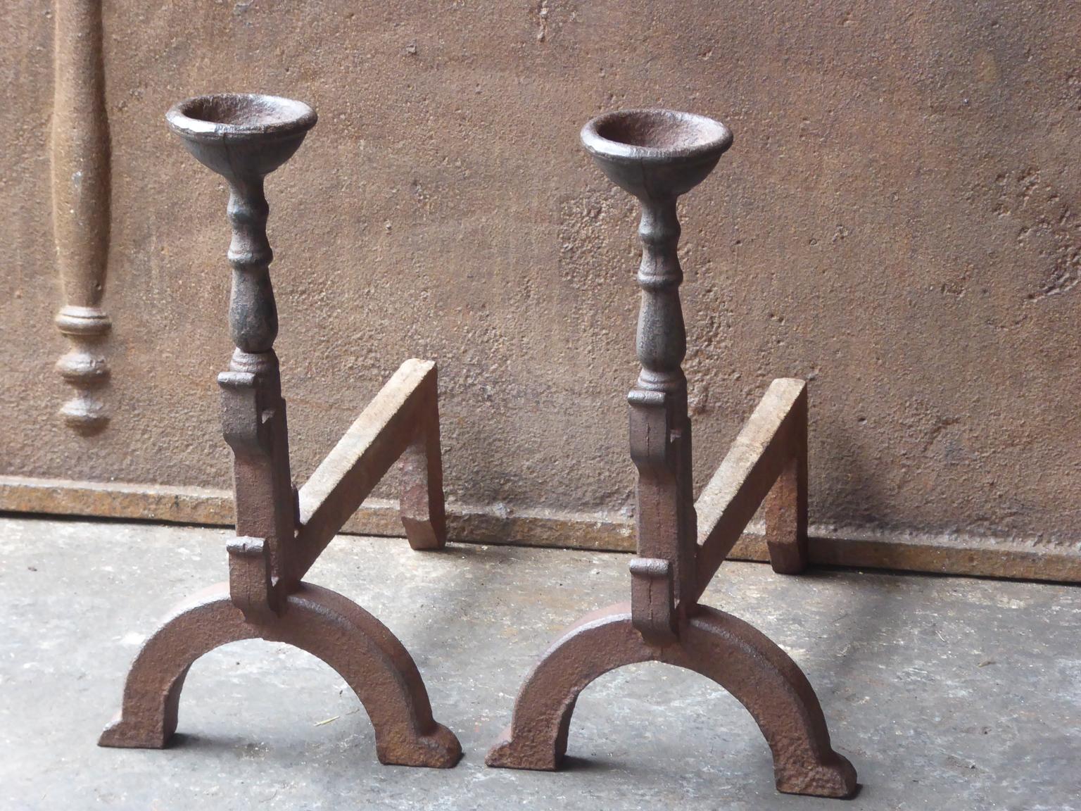 French Gothic style fire dogs made of cast iron. With spit hooks to grill food and a cup to keep drinks or soup warm. This type of andirons are also called cup dogs.







     
