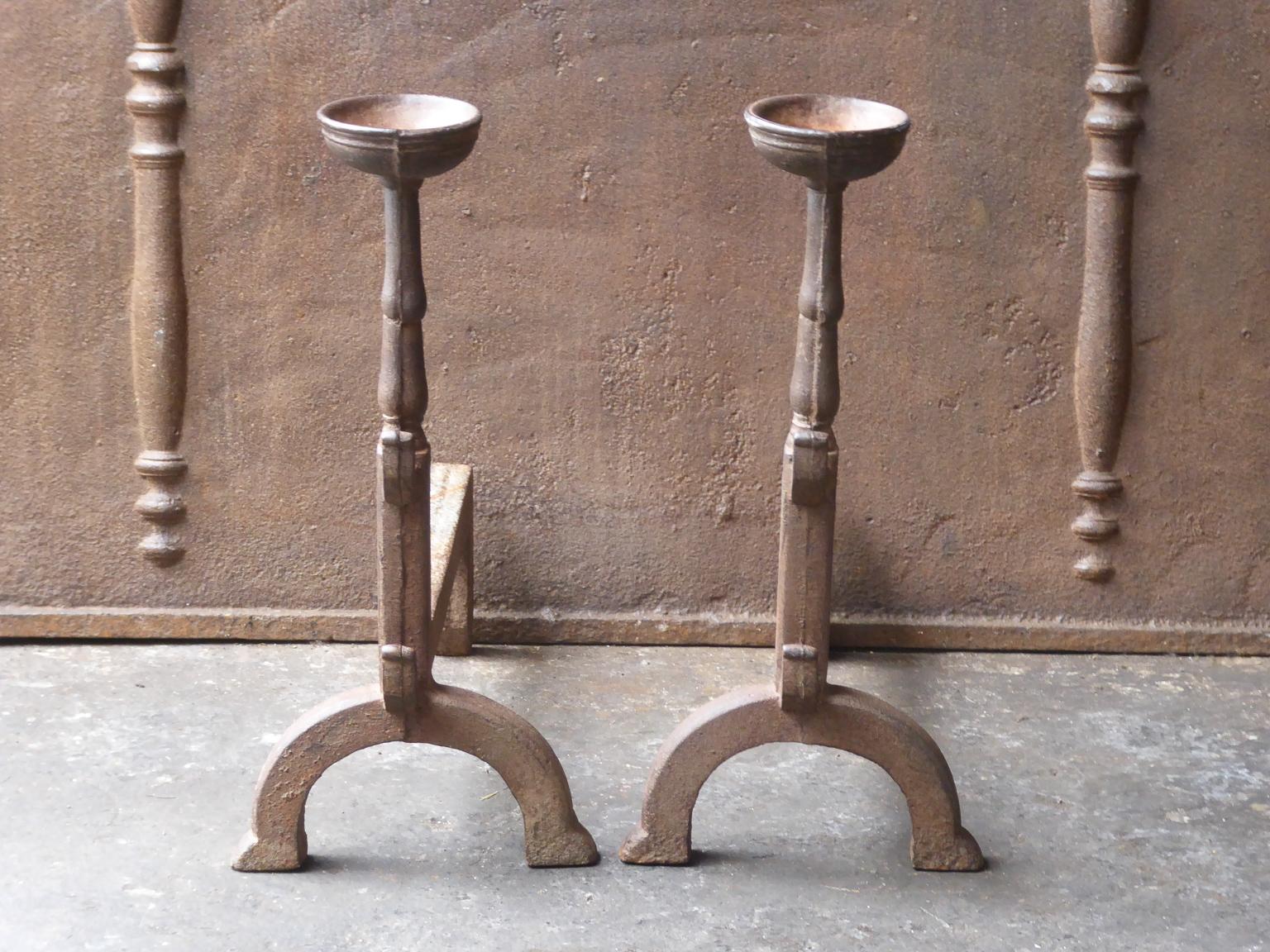 French Gothic style fire dogs made of cast iron. With spit hooks to grill food and a cup to keep drinks or soup warm. This type of andirons are also called cup dogs.







 