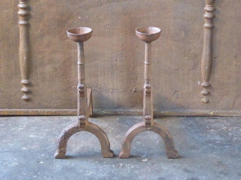 20th century French Gothic style fire dogs made of cast iron. With spit hooks to grill food and a cup to keep drinks or soup warm. This type of andirons are also called cup dogs.







   