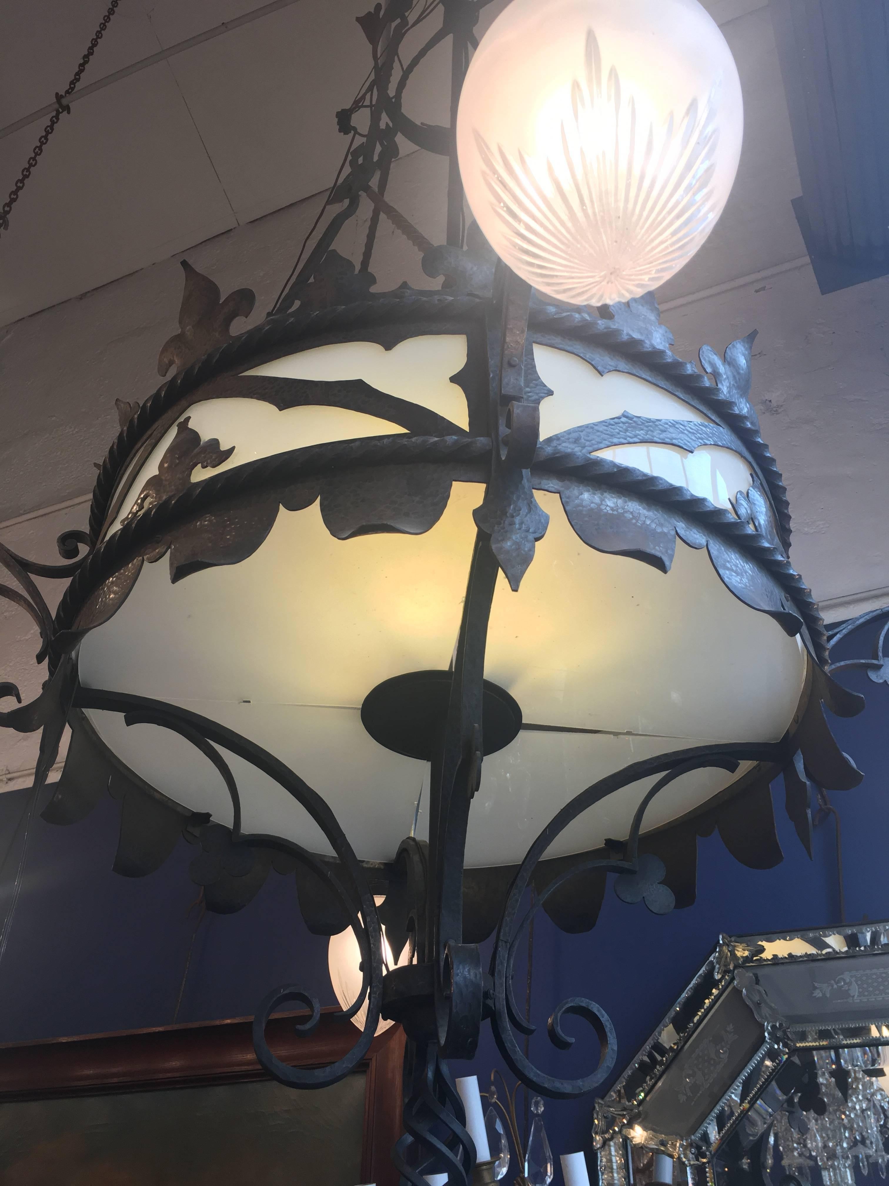 These chandeliers were made in France in the beginning of 20th century, circa 1920. This hand-wrought iron chandelier was made in the French Gothic taste - with 4 globes lights and 4 lights inside
They are two similars chandeliers 

Price 19 500 €