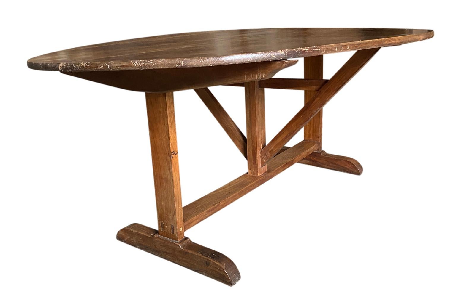 A very grand scale Table Vigneron - Wine Tasting Table from the South of France. Beautifully constructed from walnut and pine in an oval shape and tilting top. Terrific as a breakfast table or smaller dining table. Great patina.