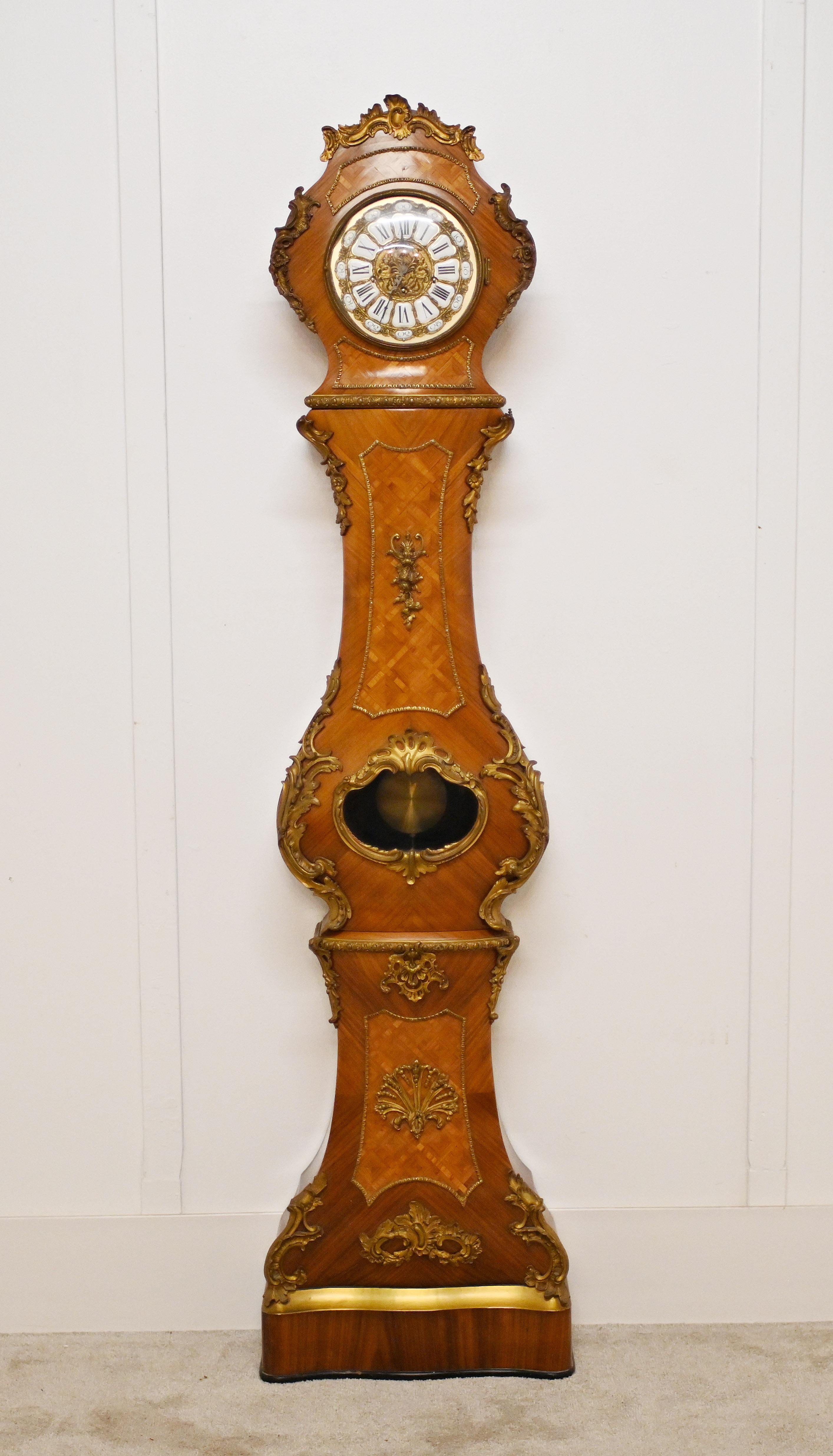 A gorgeous shaped French chimney Grandfather clock in kingwood  
Features marquetry inlays and best quality ormolu mounts 
Clock is in full working order
Circa 1930
Bought from a dealer on Rue Daphin at the Paris antiques markets
Offered in great
