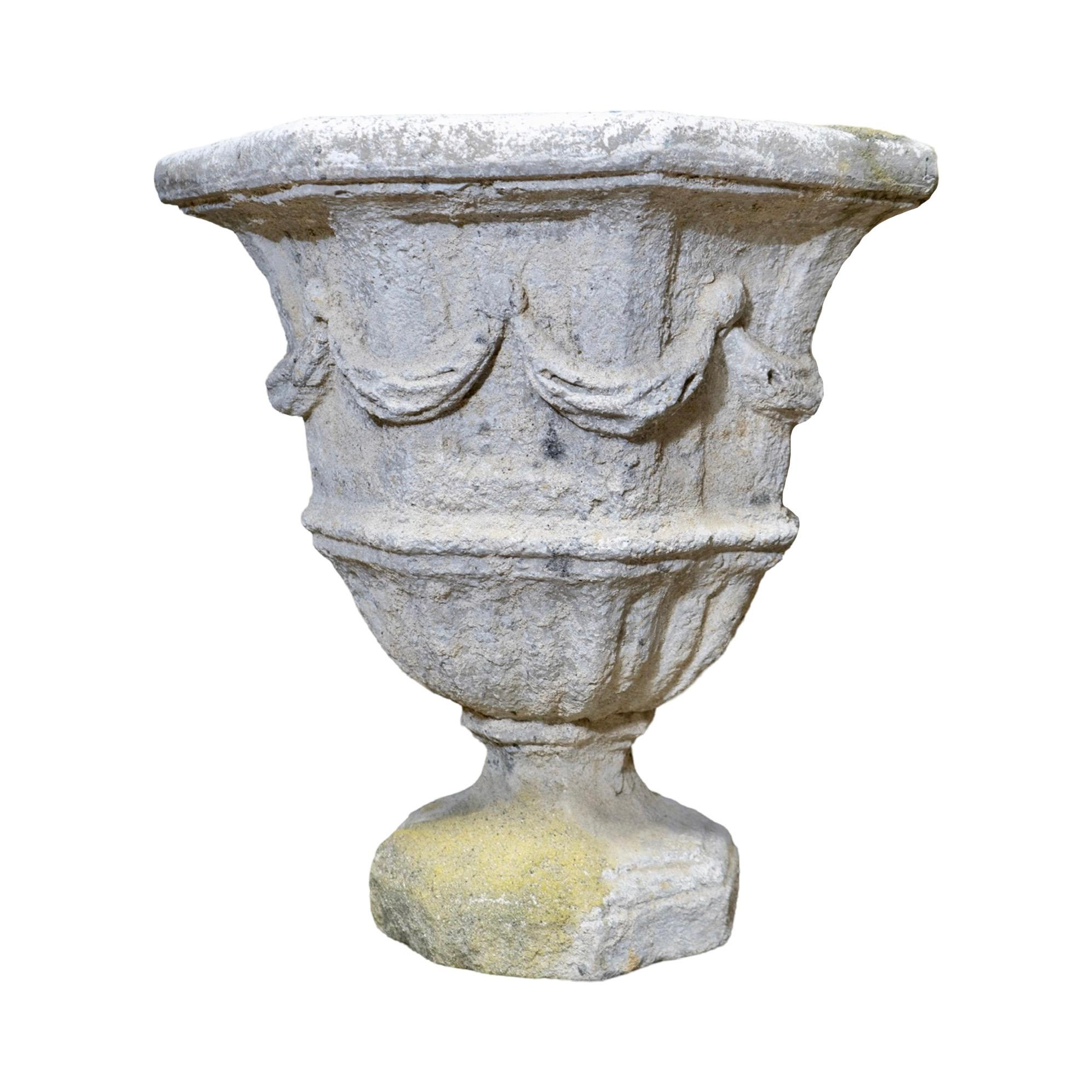 This French Limestone Planter is an antique and reclaimed piece from the contemporary period, imported from France. Made out of a durable granite composite, this octagonal-shaped planter with intricate carved swag detailing is frost-free and