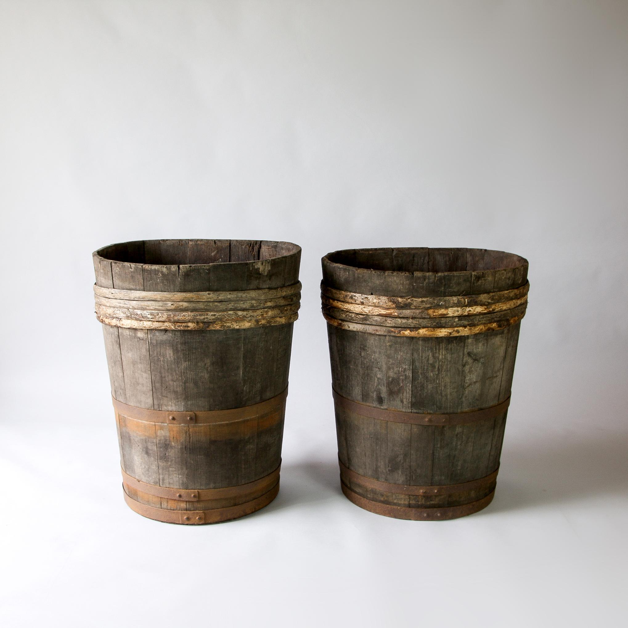 Two French oak grape harvesting barrels. These are made for use as a pair for transport on horseback. Carried by humans this type of barrel is an ‘hotte’ or hod. Carried on horseback in pairs they are ‘comportes’. Wood with cast iron handles. Great