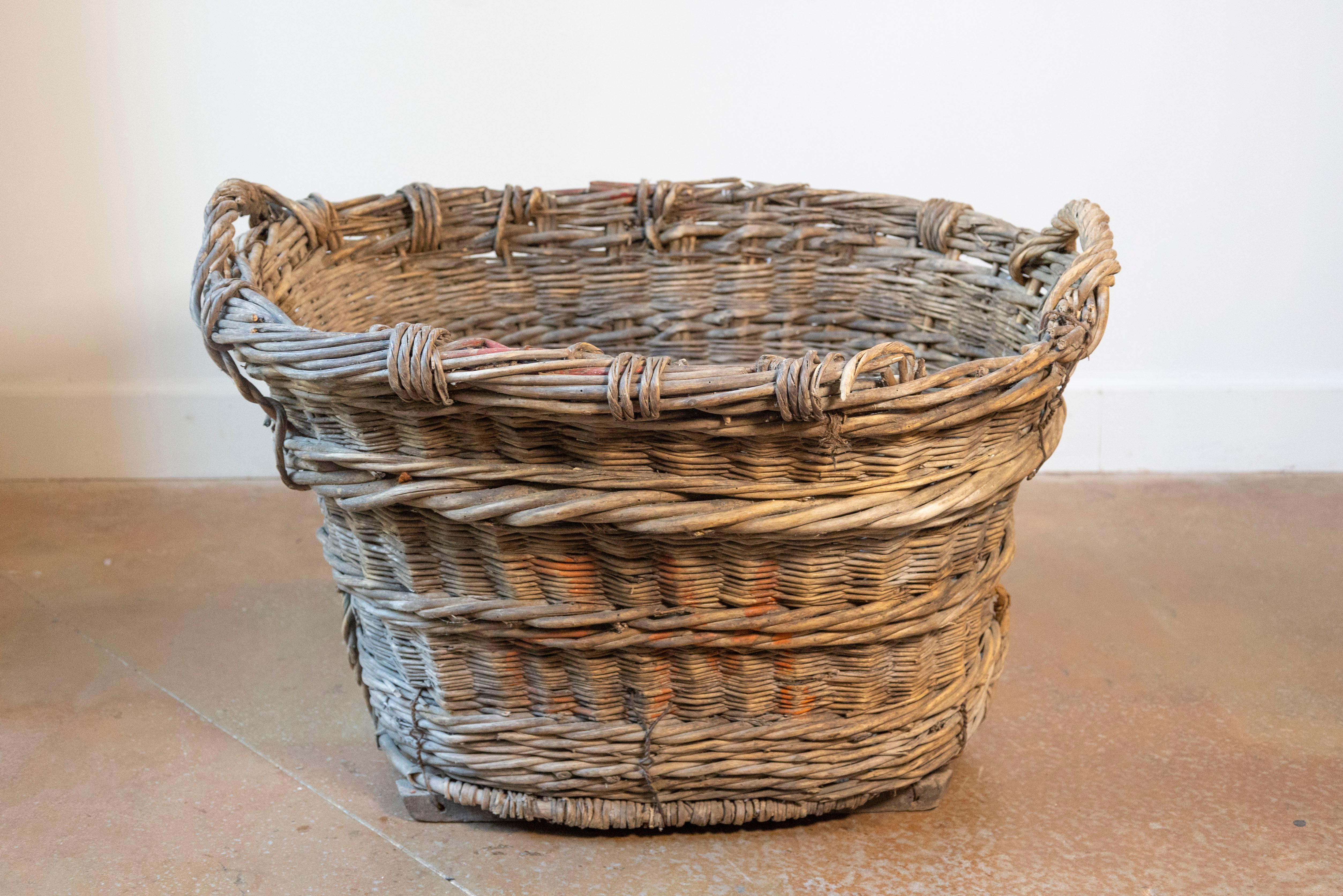 A beautifully weathered 19th-century French grape harvesting basket, handwoven from natural willow in a classic barrel form. Once used in the vineyards of southern France, this sturdy and spacious basket features double-twisted horizontal bands for