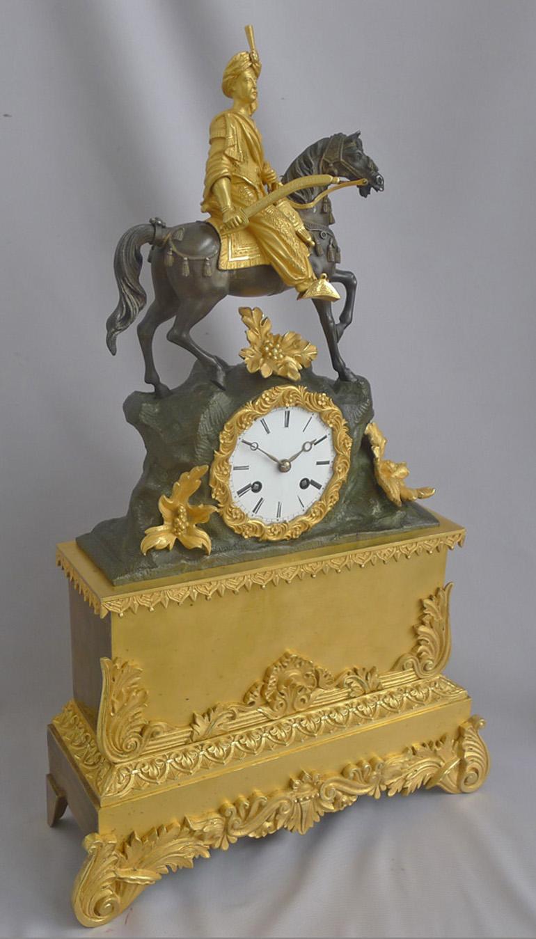 French Greek Revolution or Hellenistic mantel clock of Greek hero on horseback. Constructed of the very finest cast bronze and fire gilded ormolu and in excellent original condition. The rearing horse beautifully modelled, cast and finished in