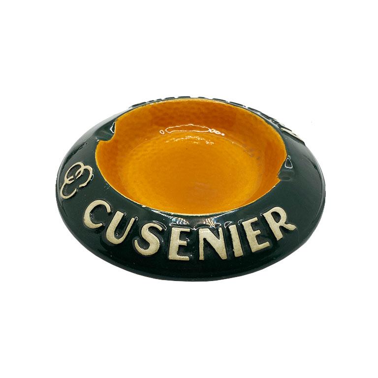 A beautiful round ceramic ashtray or catchall by Longchamp. This vintage beauty is round in form, and features a glazed rim in green, with white letters which read, 