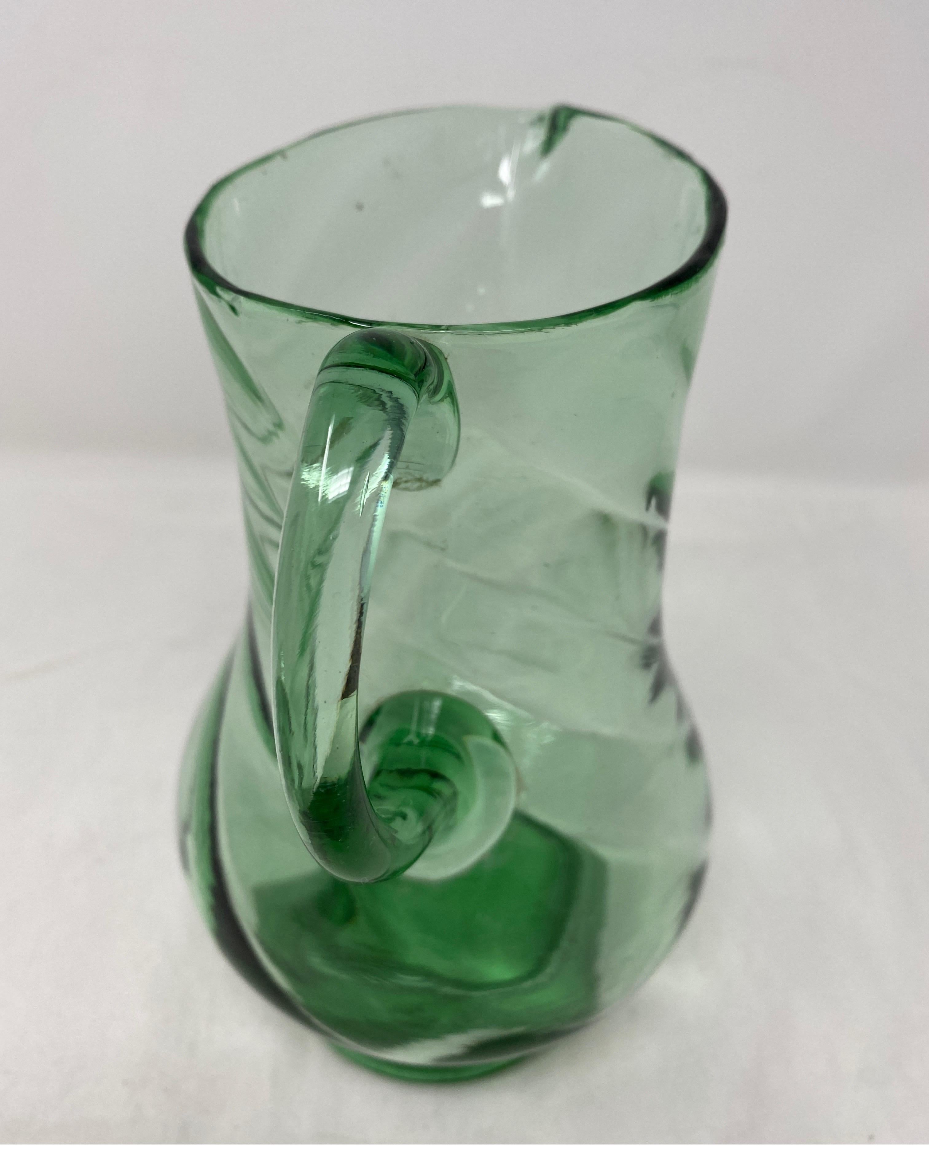 Green crystal pitcher. Beautiful dainty pitcher with a swirl pattern. 19th century.
5
