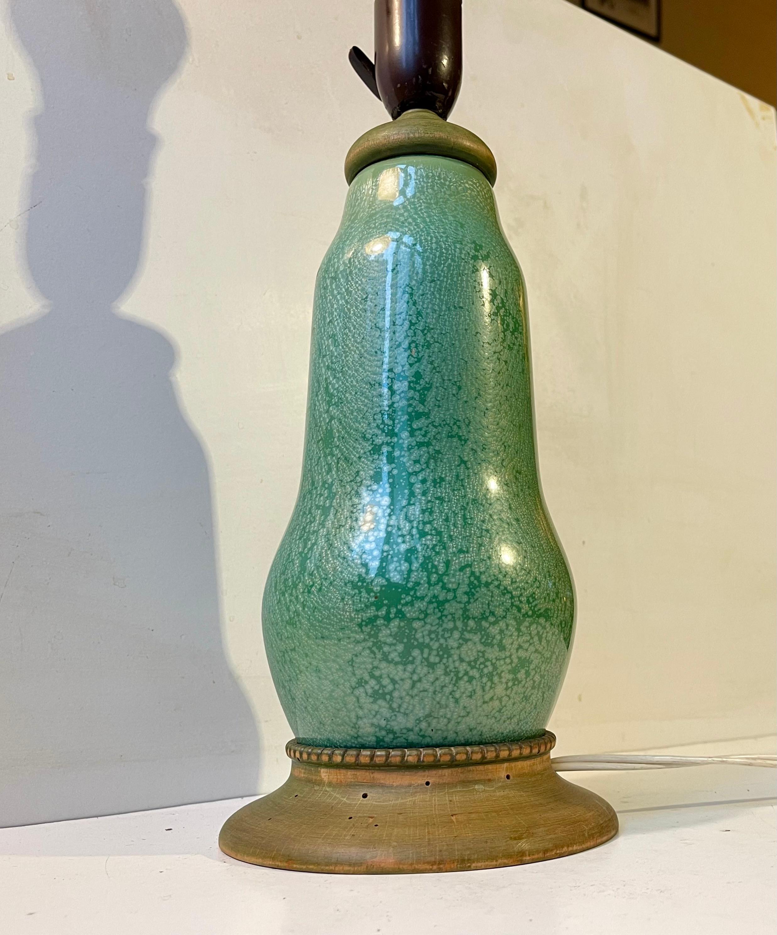 Spectacular French table lamp executed in enamel copper. The style of this gourd table lamp resembles designs by Camillé Faure and Alexandre Marty in particular. It features a wooden base and top in green lacquer. A few worm holes here and there is