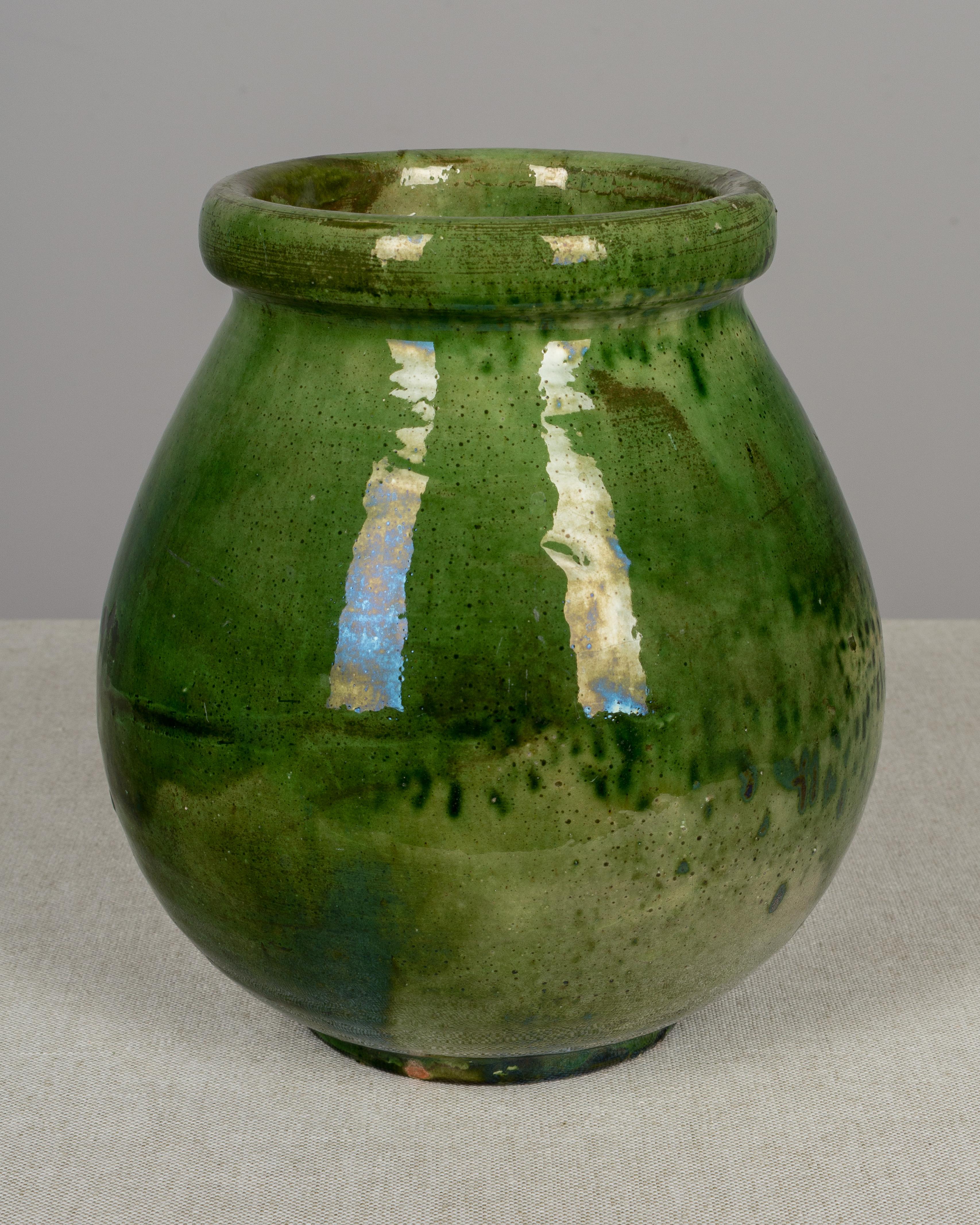 An earthenware pottery vase from the Southwest of France with traditional green glaze. We have a large collection of French pottery. Please see other listings. These ordinary earthenware vessels were once used daily in the French country home and