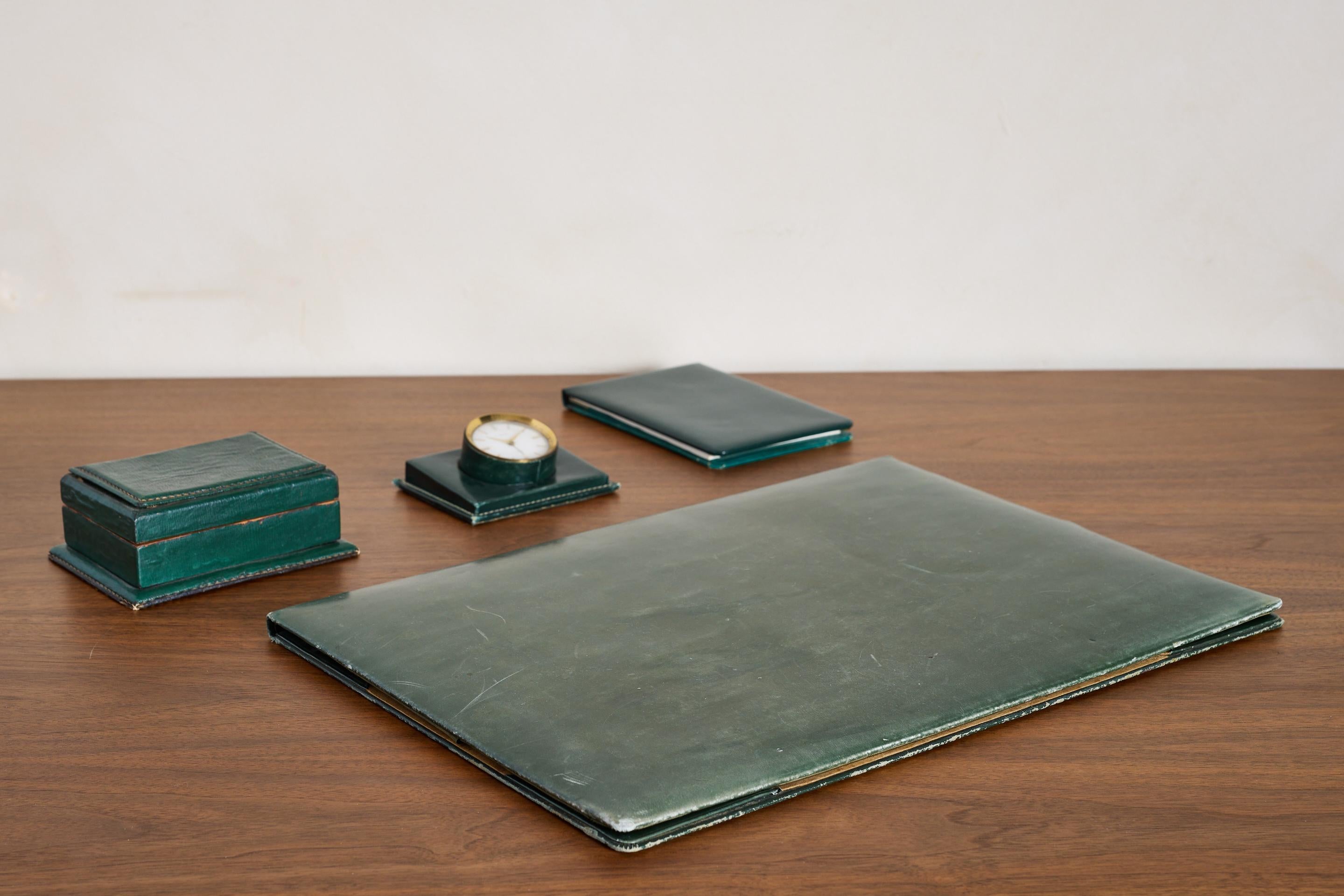 Handsome green leather desk accessory set by Le Tanneur 
France 1940's

Beautiful green patina and original brass hardware.

Clock is stamped 