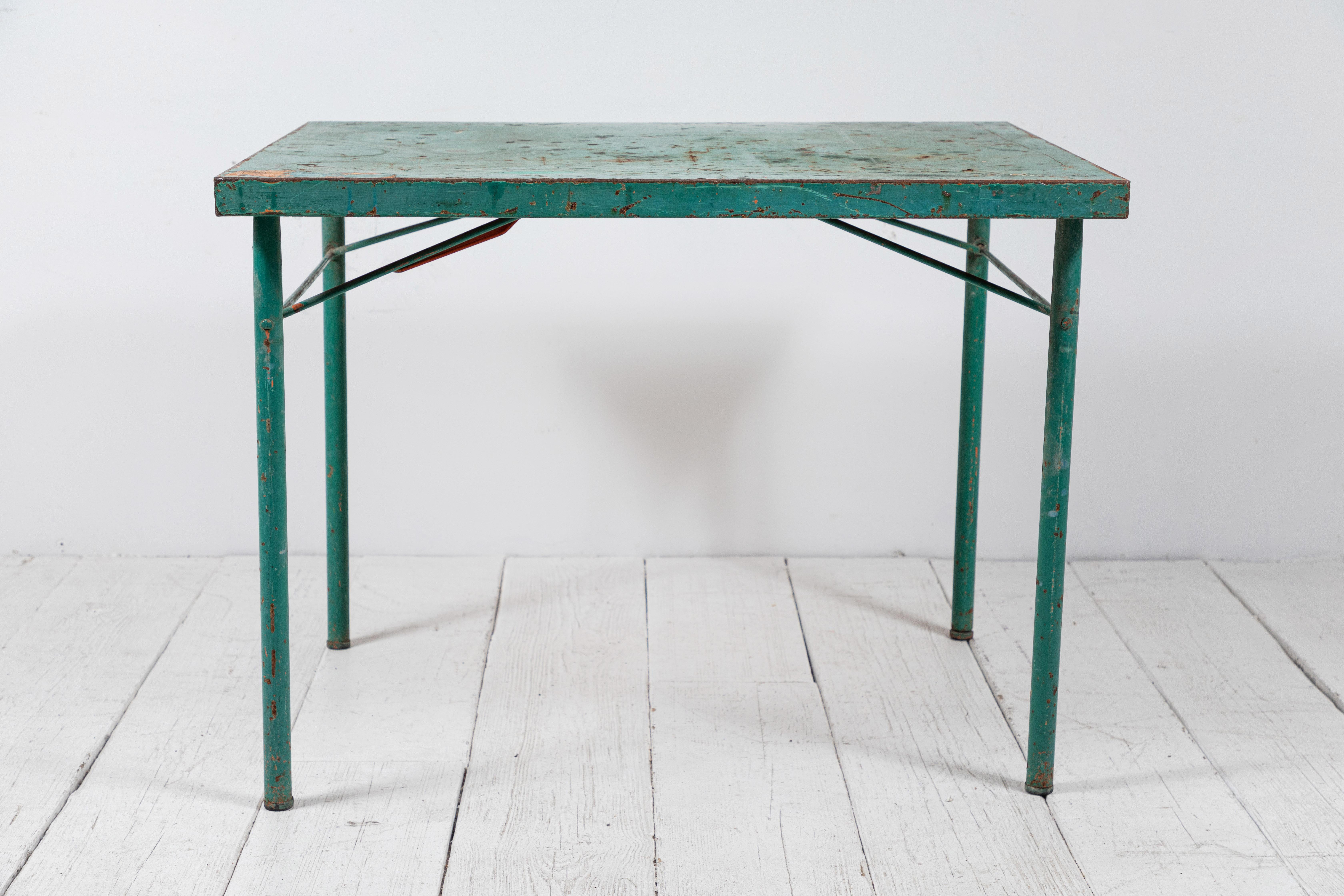 French square table with the perfect about of patina. The table make for a great garden piece or a fun game table.