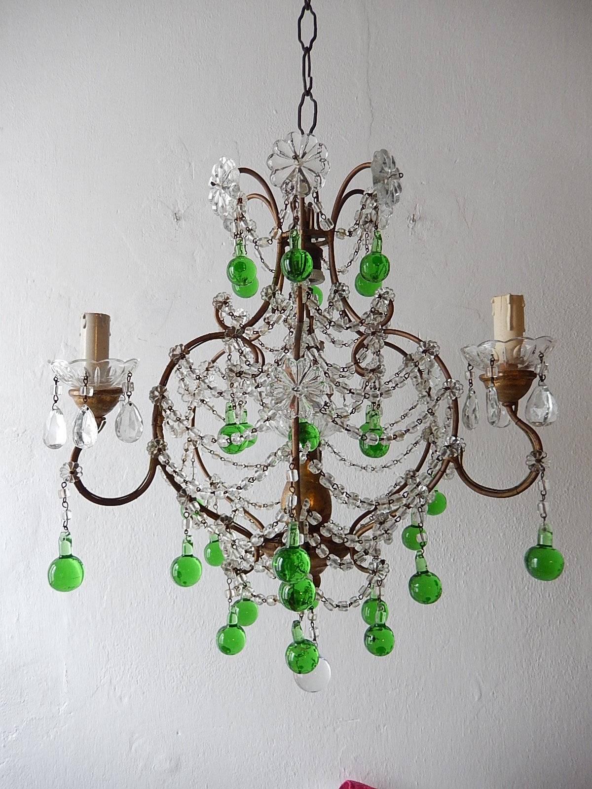 Housing one light in center and three encircling, rewired and ready to hang. Giltwood posts with crystal bobeches dripping with crystal prisms. Giltwood center and bottom with another crystal bobeche. Adorning short bulbous Murano green balls and