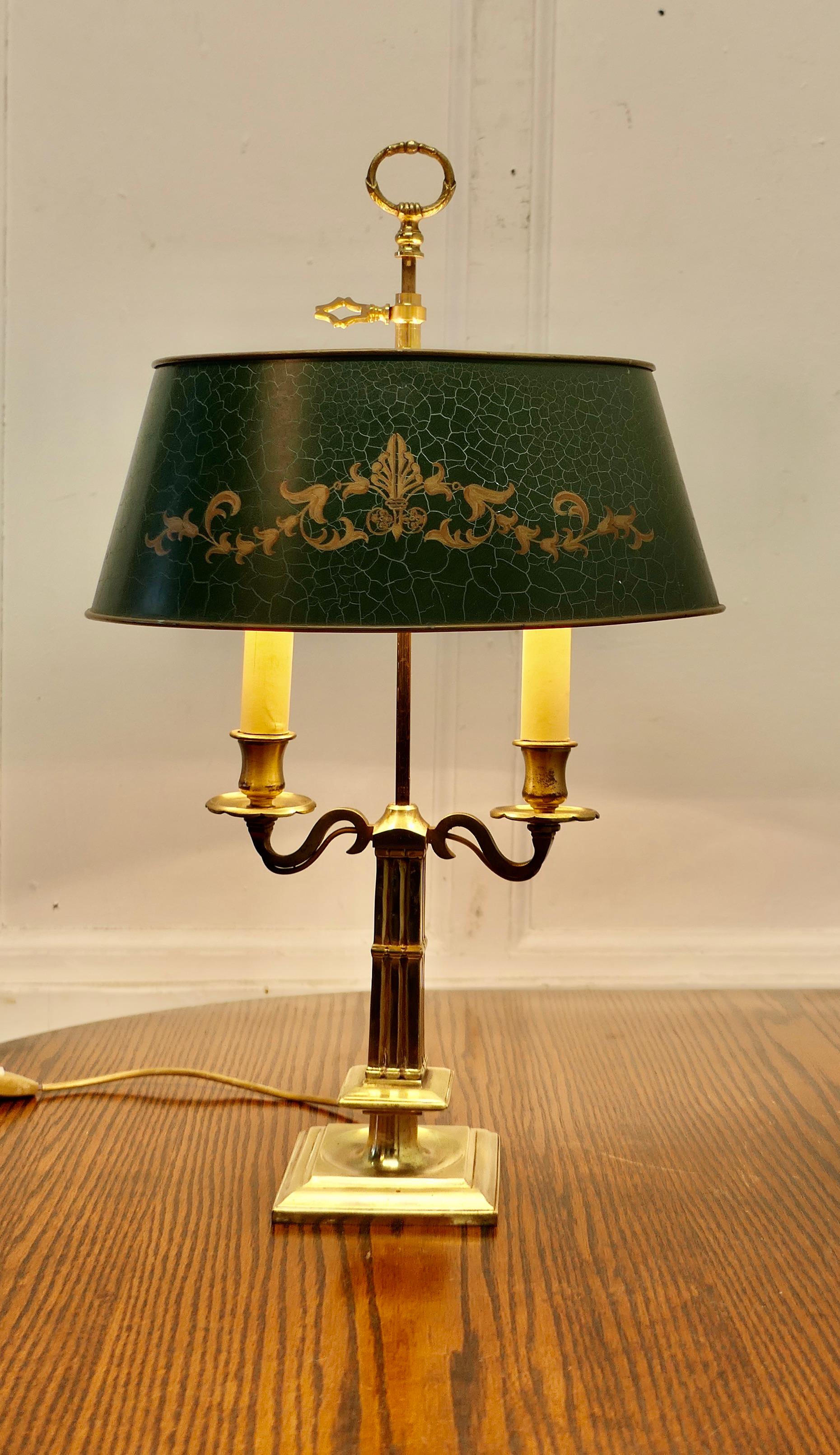 French Green Toleware and Brass Twin Bouillotte Desk Lamp

A lovely piece, a double brass sconce lamp with its original adjustable toleware shade 
A  Very traditional design with a centre column and shaped grip to adjust the shade
The shade is in