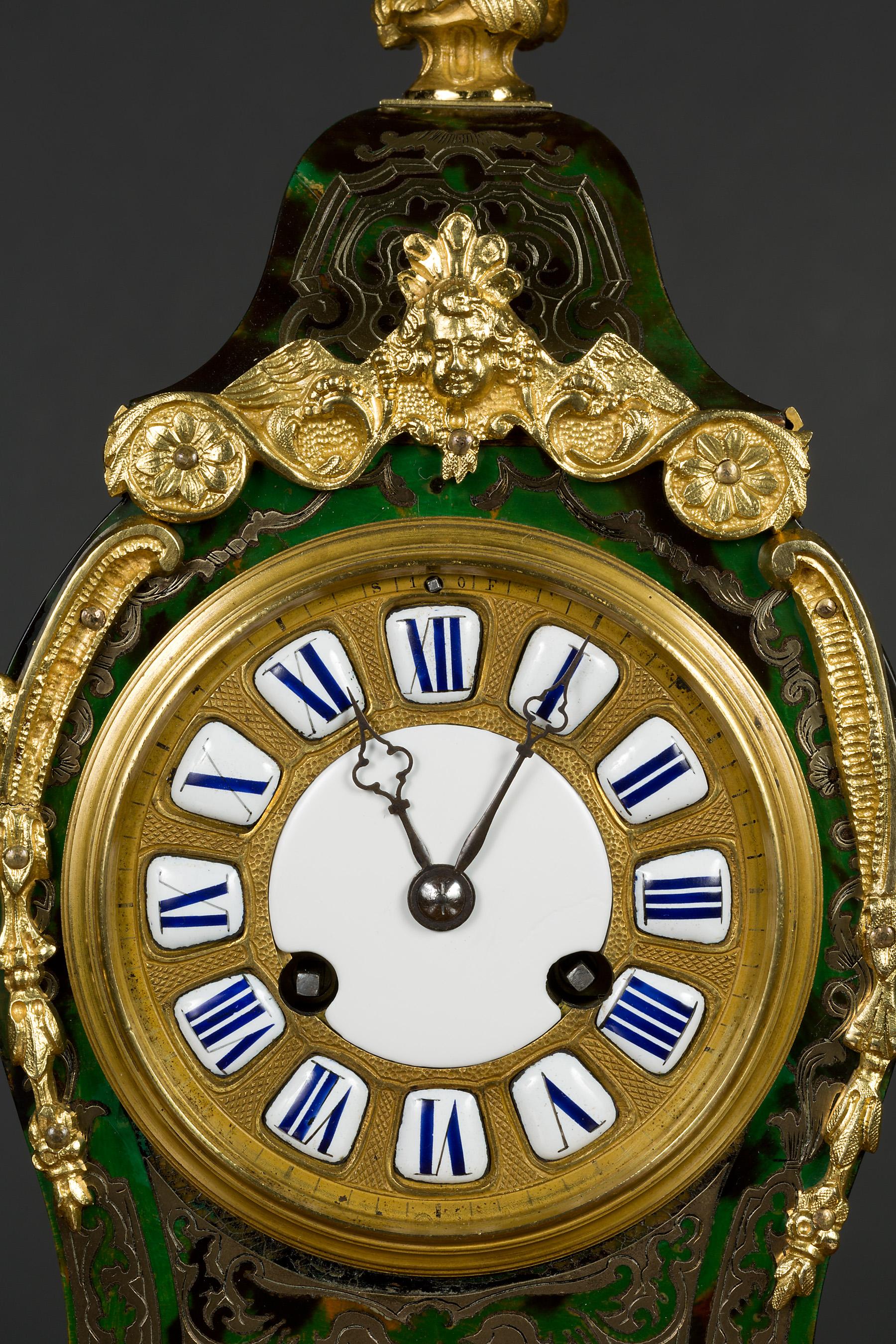 Fine French Tortoiseshell Boulle Clock

Waisted case with green ‘tortoiseshell’ inlaid with fine brass decoration surmounted by an ormolu finial, ormolu mounts throughout and standing on raised bracket feet. The sides and rear door also decorated