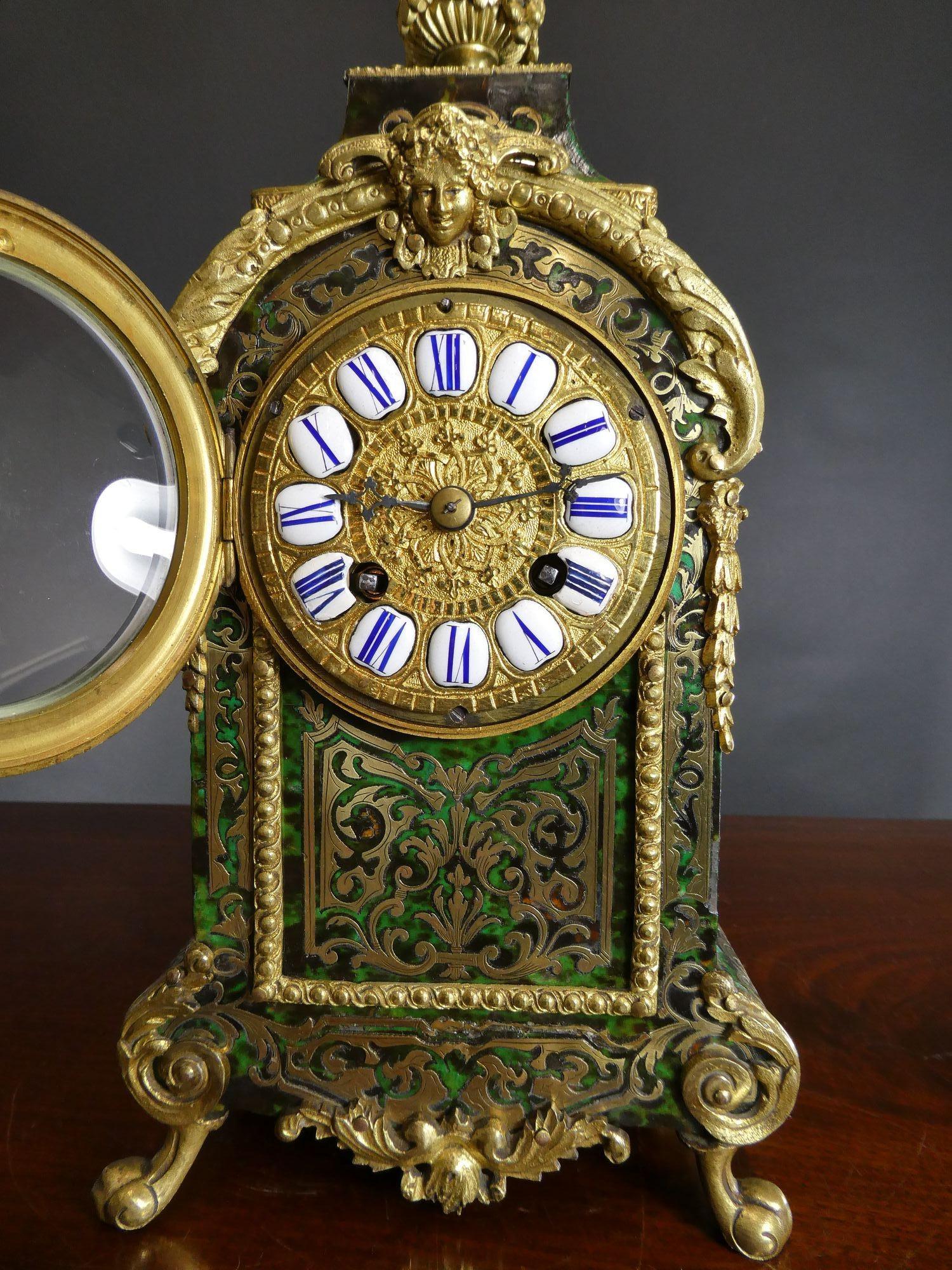 Fine French Tortoiseshell Boulle Clock
Straight sided case with green ‘tortoiseshell’ inlaid with fine brass decoration surmounted by an ormolu finial, ormolu mounts throughout and standing on raised bracket feet. 
Gilded and chased dial with