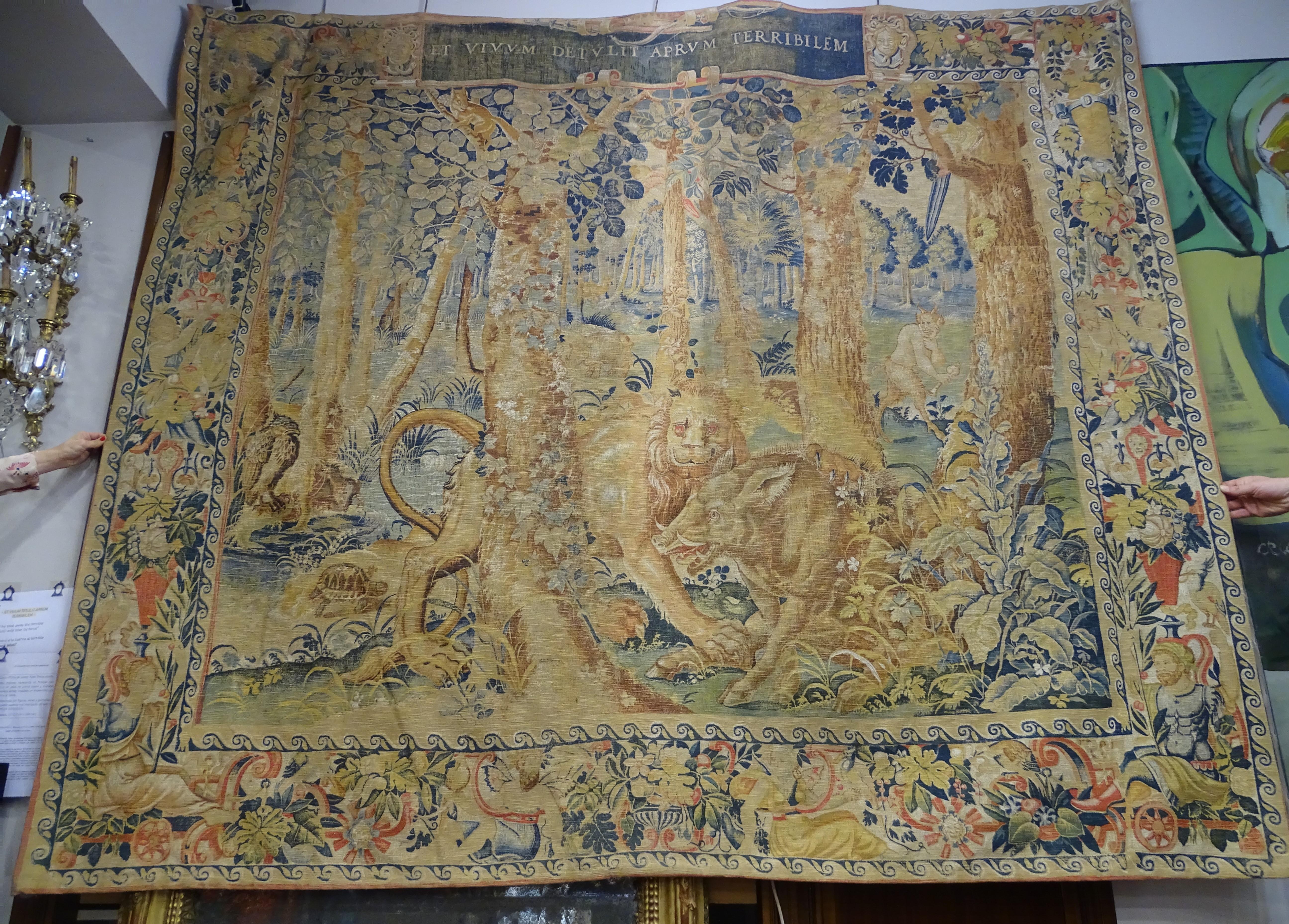 Outstanding French tapestry, printed scene depicts a forest with a lion attacking a boar in the foreground and exotic creatures in the undergrowth in the background, including a rhinoceros, tortoise, camel, and satyr.
In green, red, blue and brown