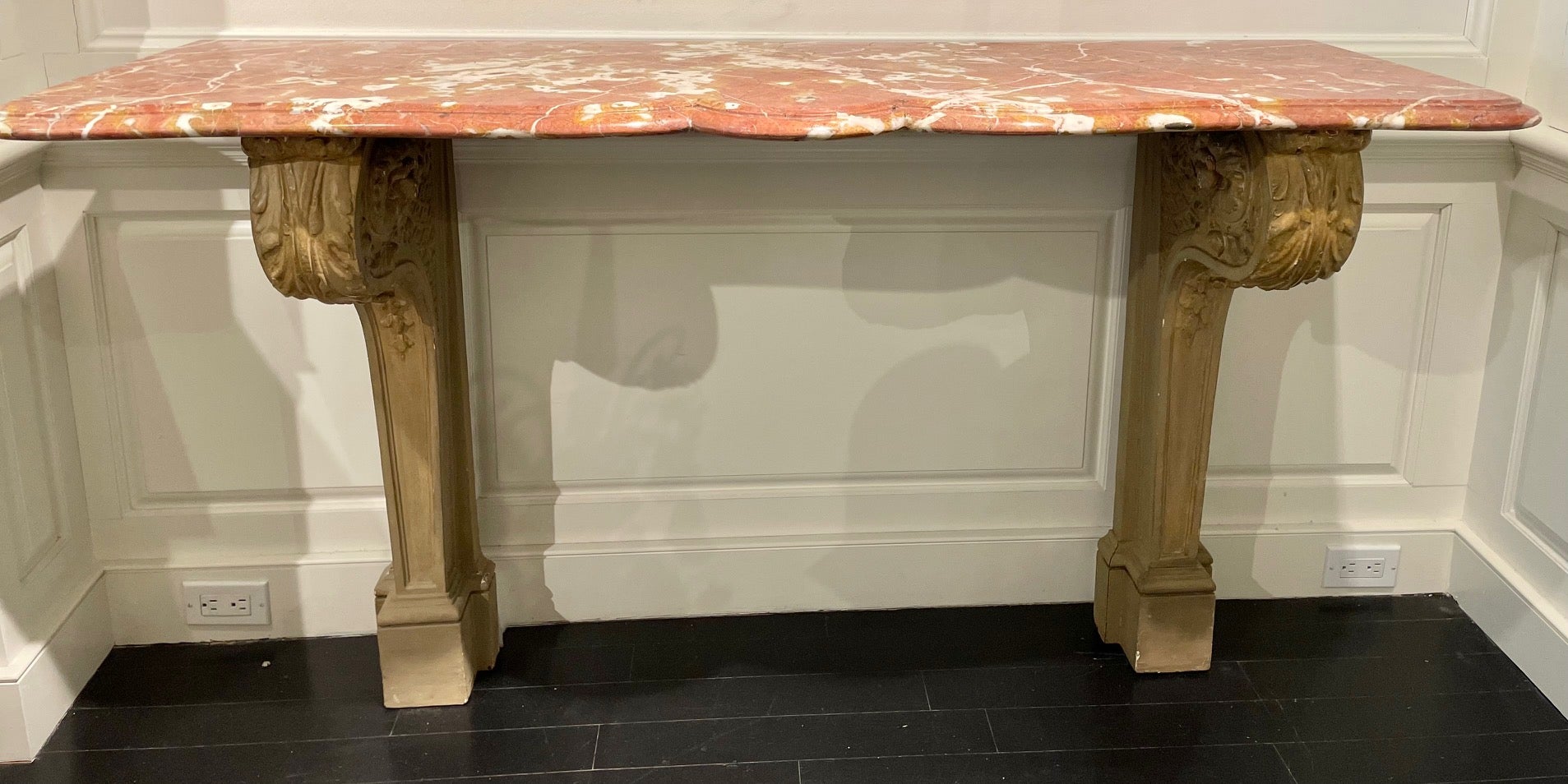 This stunning French console with a shaped breche d' alep marble top above elegant stone foliate carved supports was prominently displayed in Lee Radziwill's London residence for many years (see picture of the console off the main salon in her