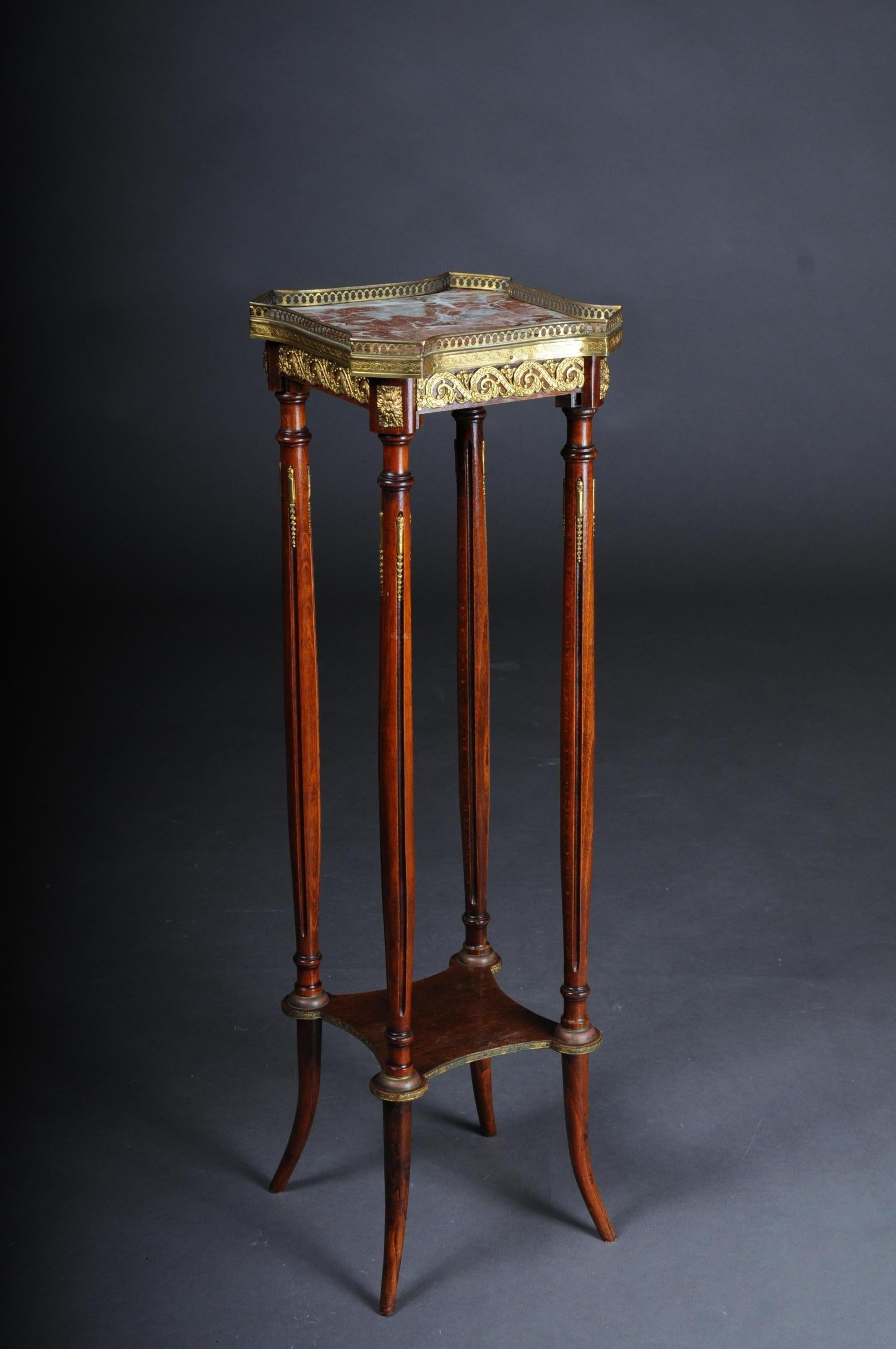 French Gueridon side table with bronze Napoleon III

Solid mahogany wood with rich brass trim. Four-pass marbled cover plate with brass gallery edging on fluted pillar frame with clipboard. France at the end of the 19th century.