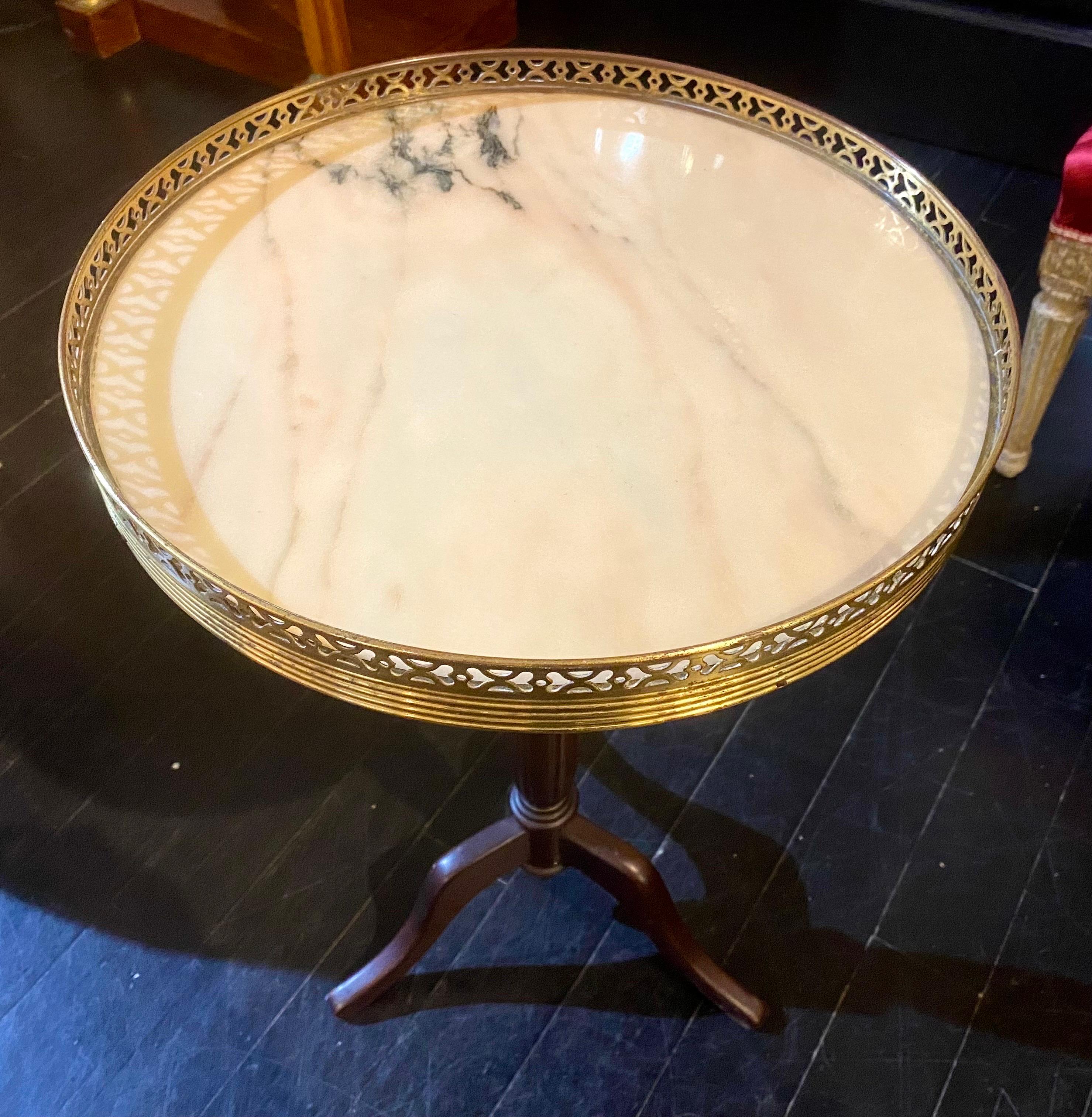 This French Guéridon is made up of a circular marble tabletop and a pierced bronze galerie. From the French homes of Hubert de Givenchy to the fashionable apartments of New York City, these little guéridon tables have been in style for over a