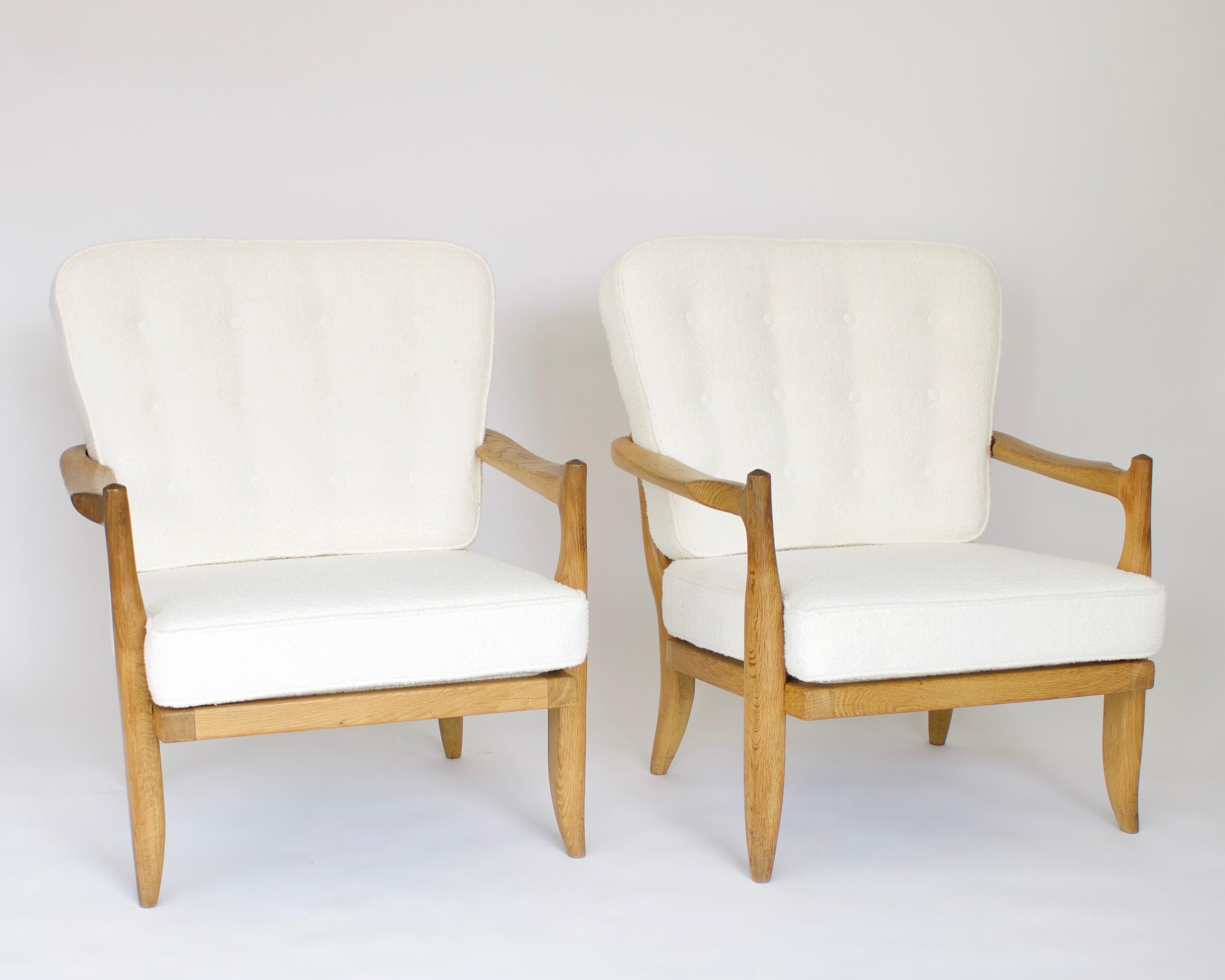 Two French Gullerme et Chambron or Guillerme and Chambron lounge chairs model Jose in natural oak for Votre Maison. 
This pair of the model Jose lounge chairs have a very sculptural back not seen on other models of Chambron chairs and have an