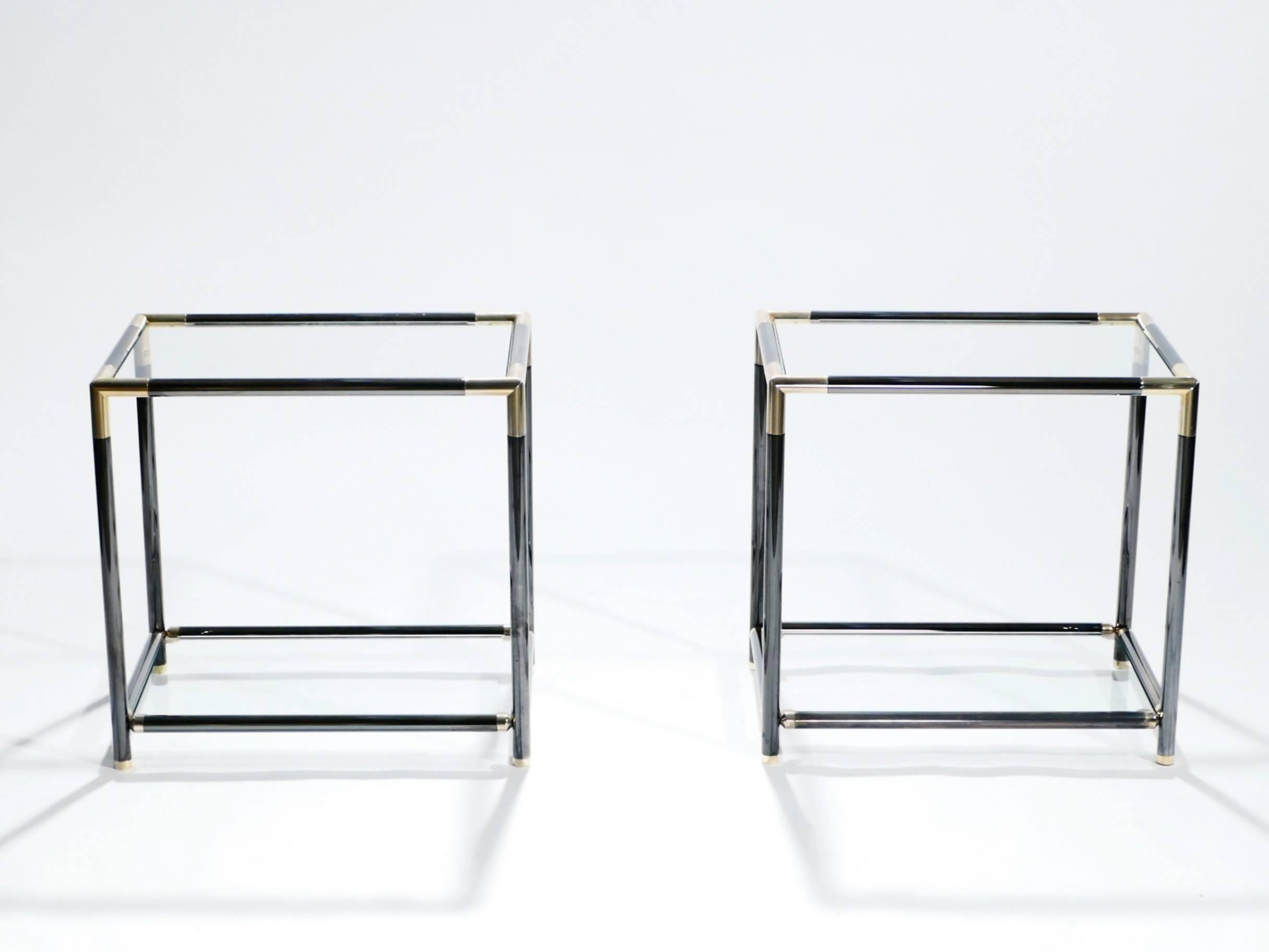 The designer of this pair of gunmetal and brass side tables aimed to emulate the simple structure and visual drama of Maison Jansen’s iconic style. Sleek lines and an ordinary rectangular structure are offset by bright brass joints at all four