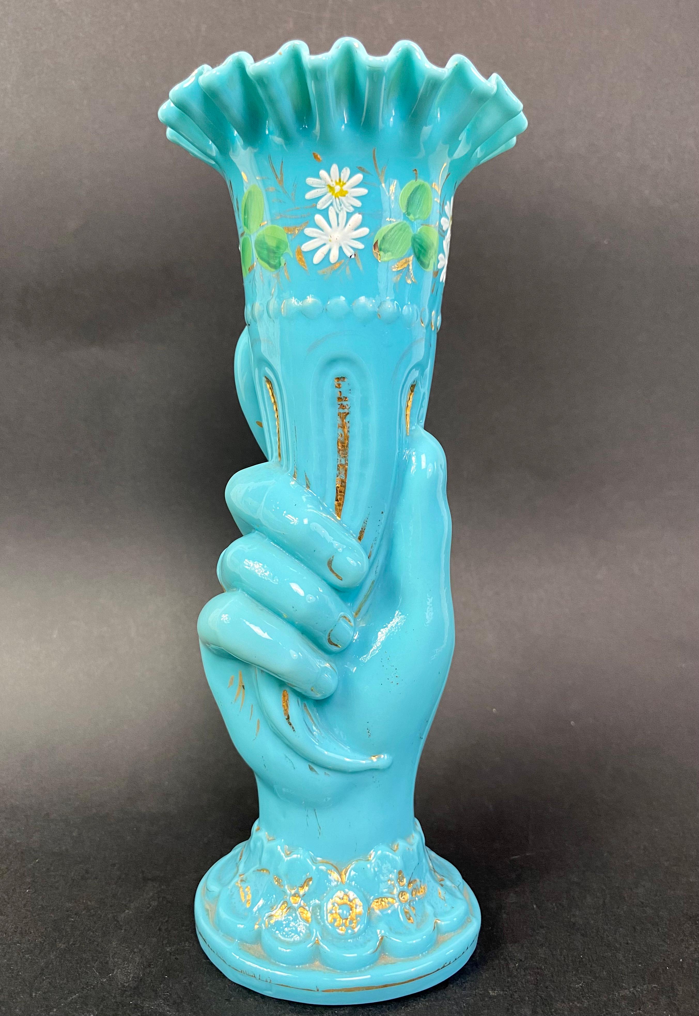 Blown blue opaline vase from the Portieux Vallerysthal crystal factory representing a hand holding a cornucopia and dating approximately from the 1920s
“Cornet” vase or “Main” vase
The ring finger wears a ring and the base represents the wrist of a