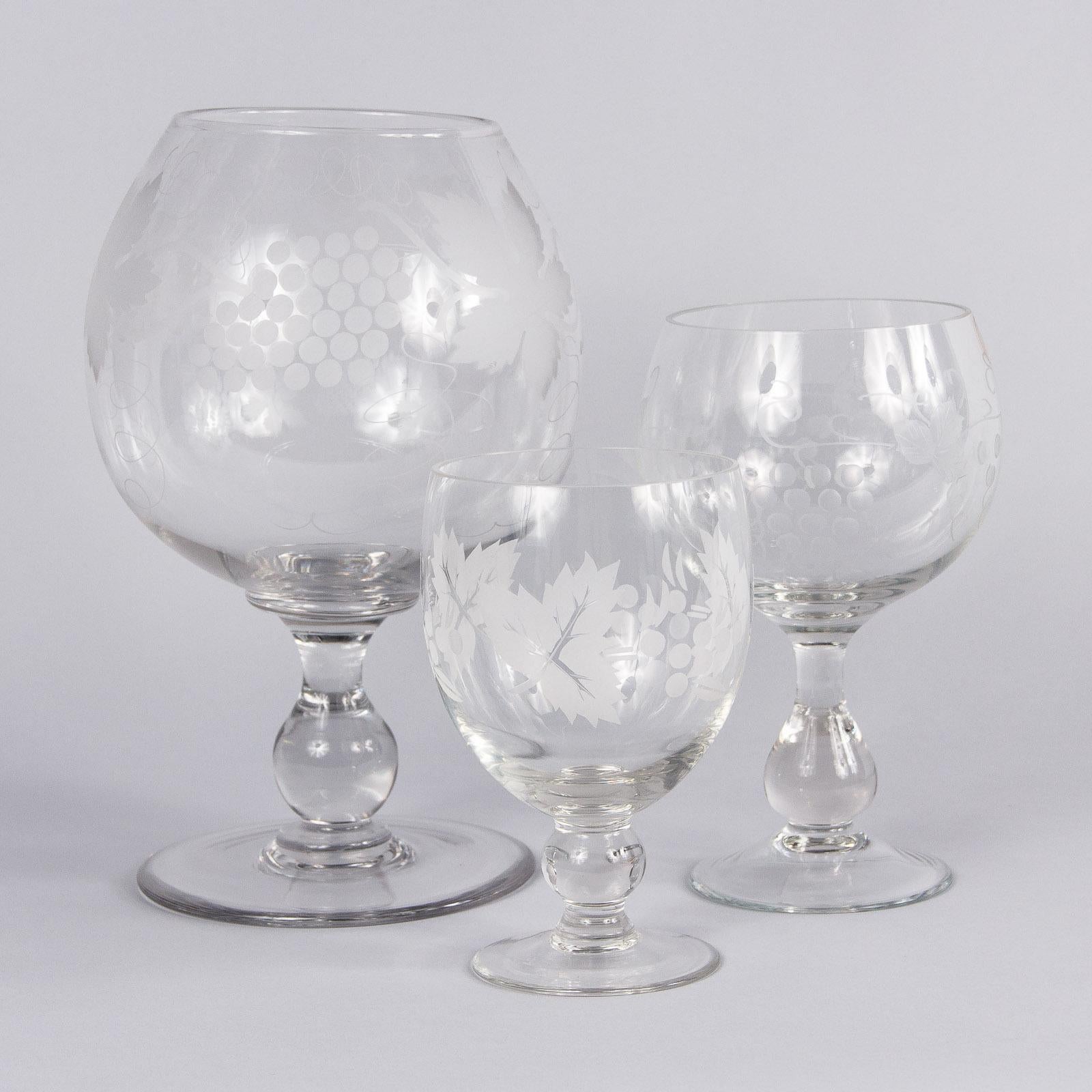 An oversized and decorative hand blown crystal wine glass with etched grapes and vine motifs from the Beaujolais region of France.