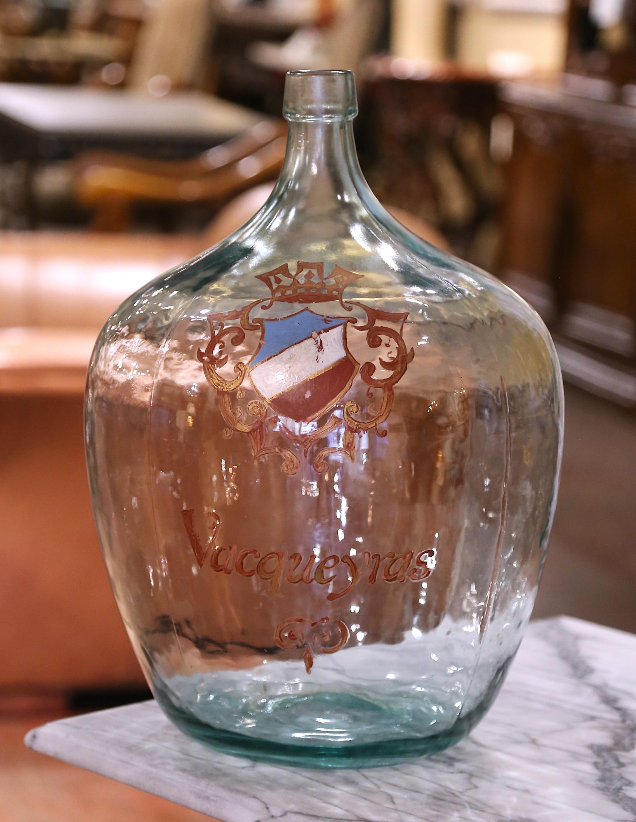 Store your wine corks in this Classic French wine bottle! Hand blown in France, this tall glass bottle features a hand painted gilt family crest with the following word 