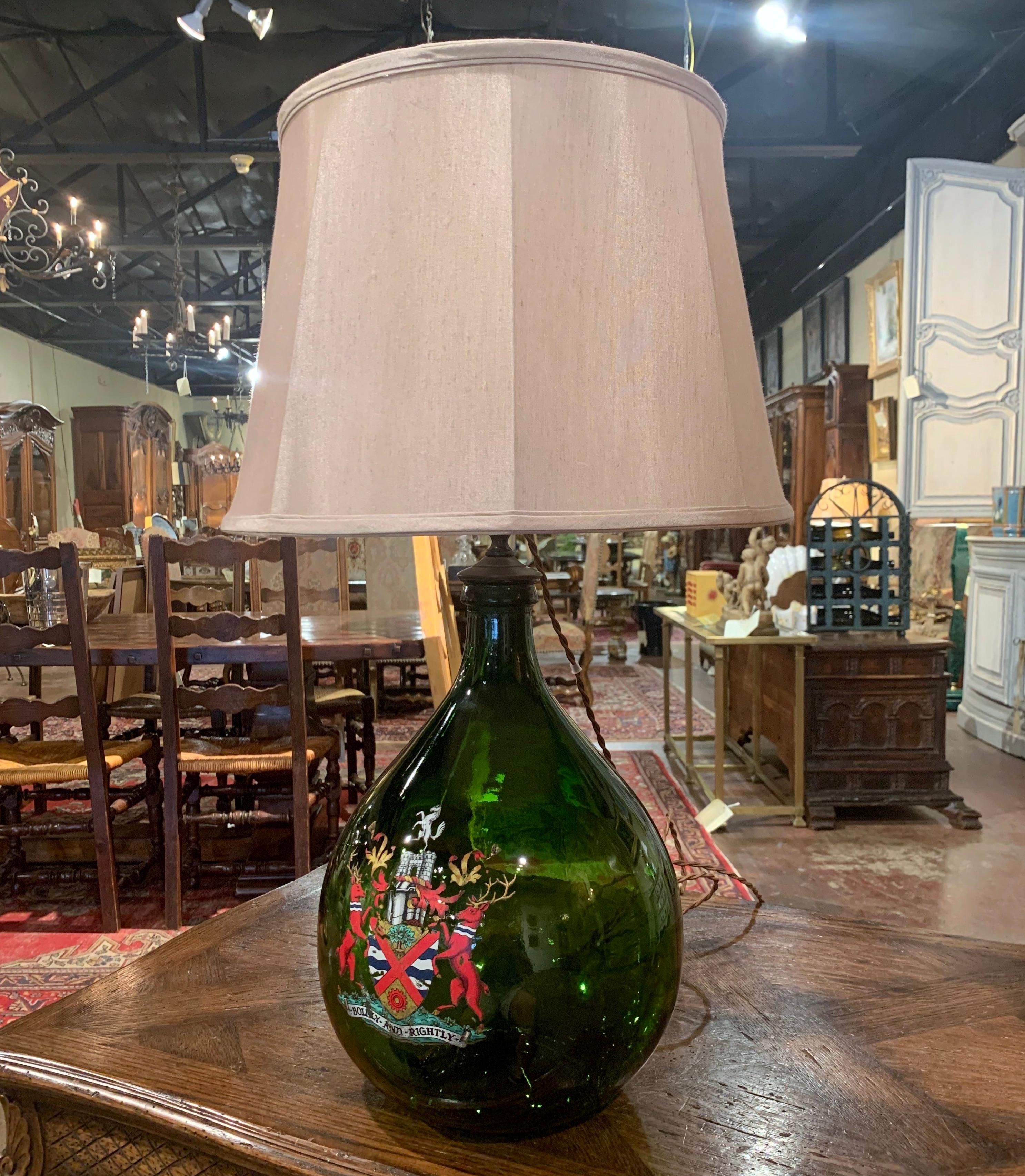 Decorate a wine cellar or a wet bar with this Classic table lamp! Hand blown in France, this glass bottle with green shade features a hand painted crest embellished with Royal motifs, and was converted into an elegant fixture with new wiring. The