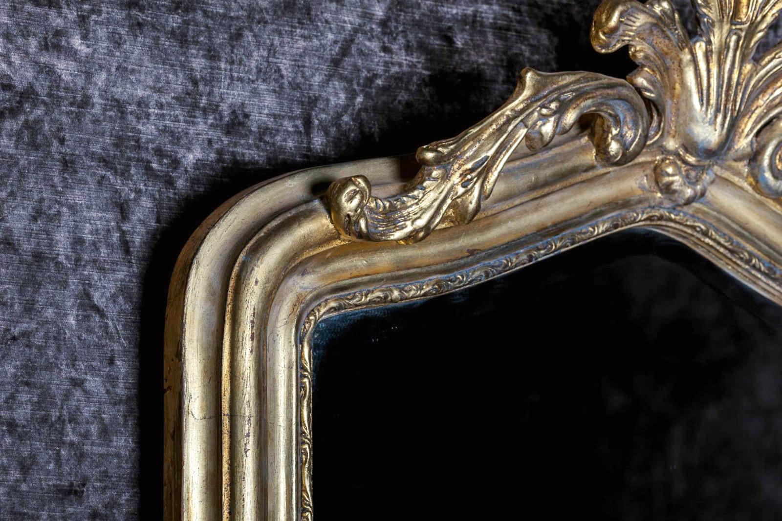 This French hand carved beveled mirror in hand gilt frame was hand carved with beaded detail and an exquisite aged gilt painting technique. The piece itself was created in Biarritz, France, and has a lovely beveled edge mirror installed. The subject