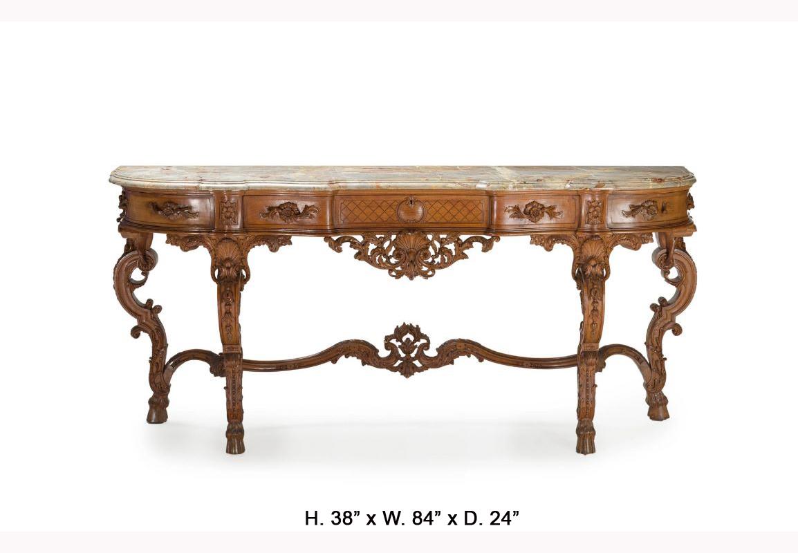 A 19th century magnificent French hand carved walnut console table with marble top.
The shaped and moulded thick marble top is over a finely hand carved frieze, fitted with two corner drawers centered by one long drawer, above a foliate-inspired