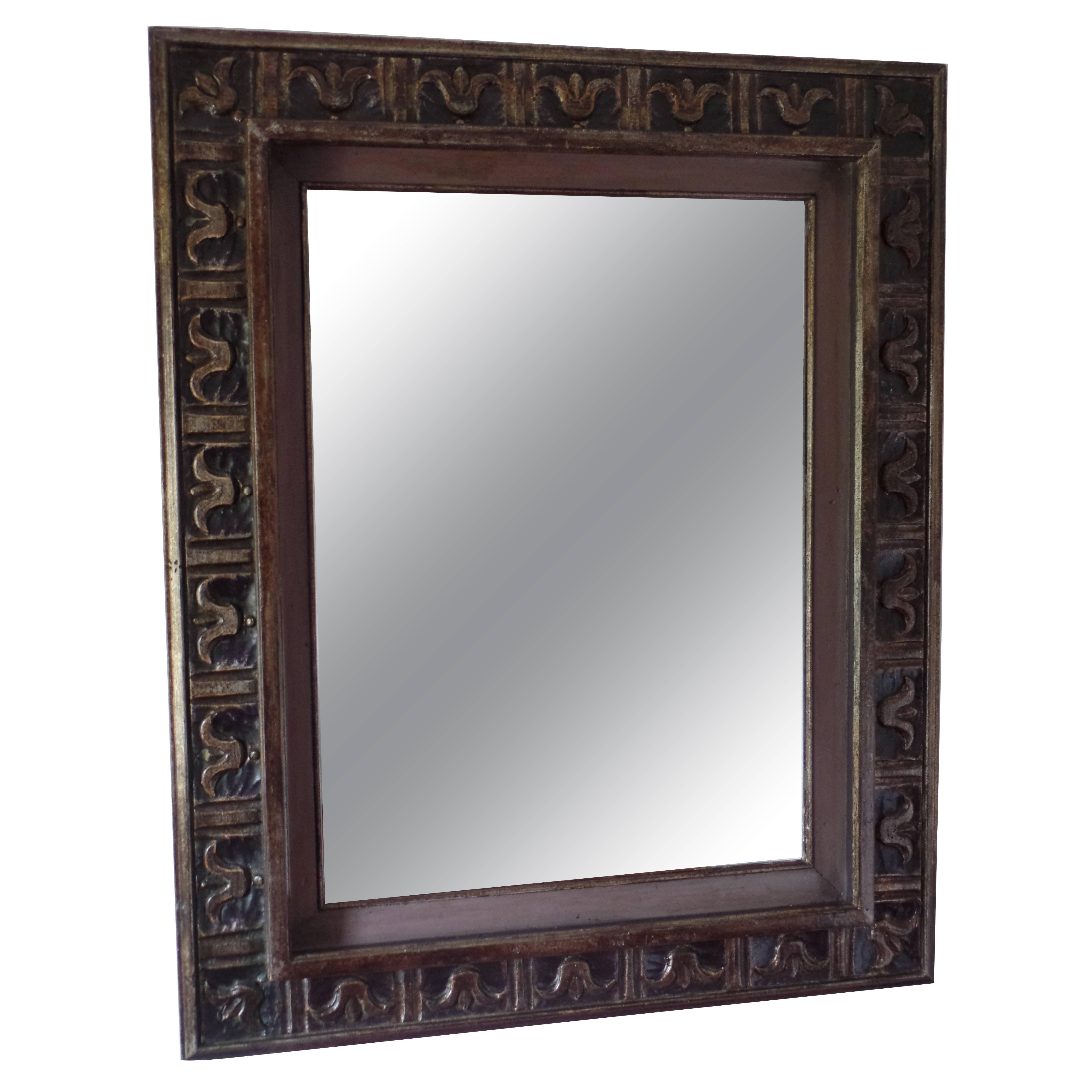 French 1940 wall mirror / frame in the modern neoclassical spirit with carved fleur d'lys motifs and Doric columns arranged sequentially around the border of the frame. The frame is highlighted with subtle silver and gold leafed details against a