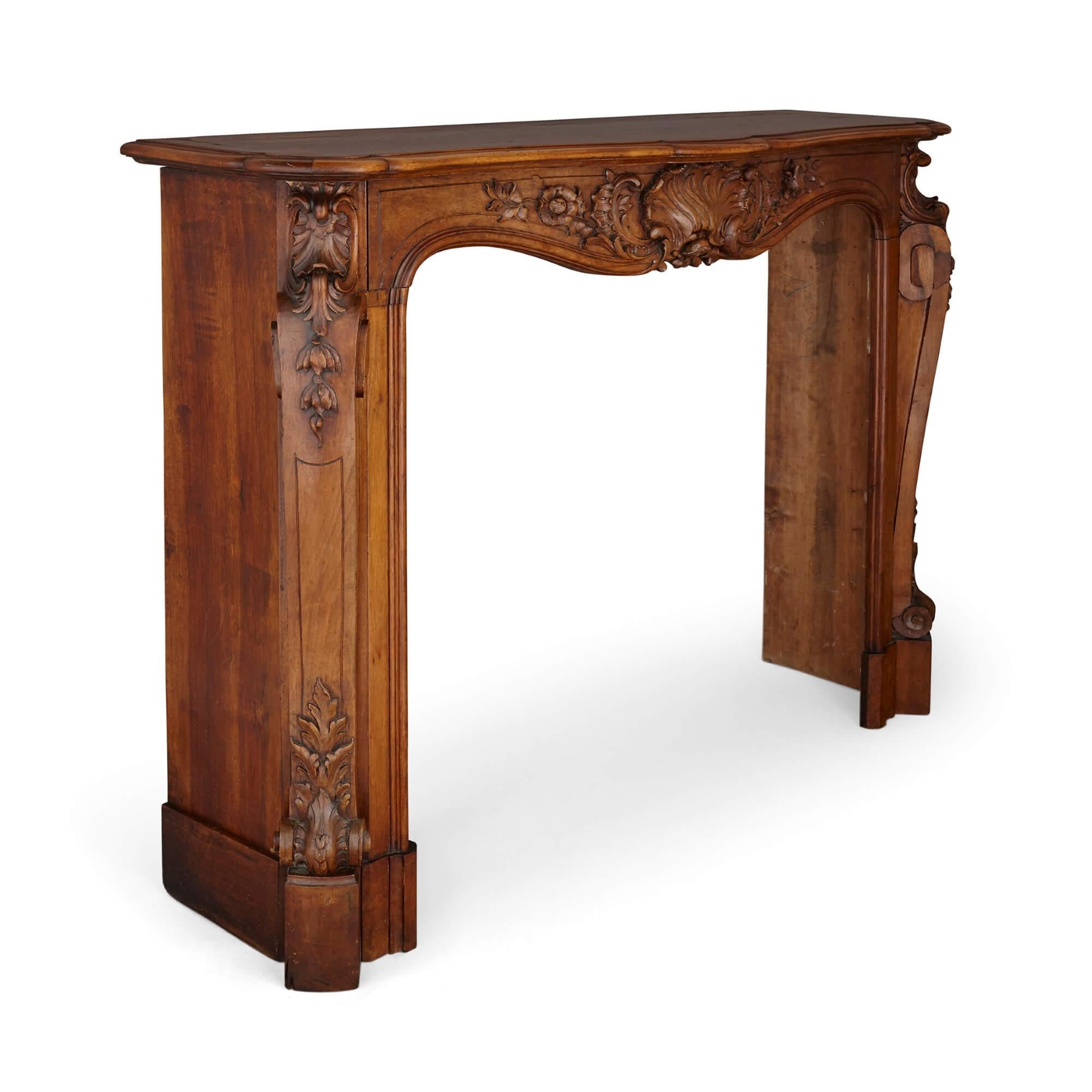 French hand-carved walnut fireplace
French, late 19th century
Measures: Height 121cm, width 160cm, depth 45cm

This beautiful fireplace surround is a wonderful demonstration of wood carving. The fireplace is made from walnut, which has been