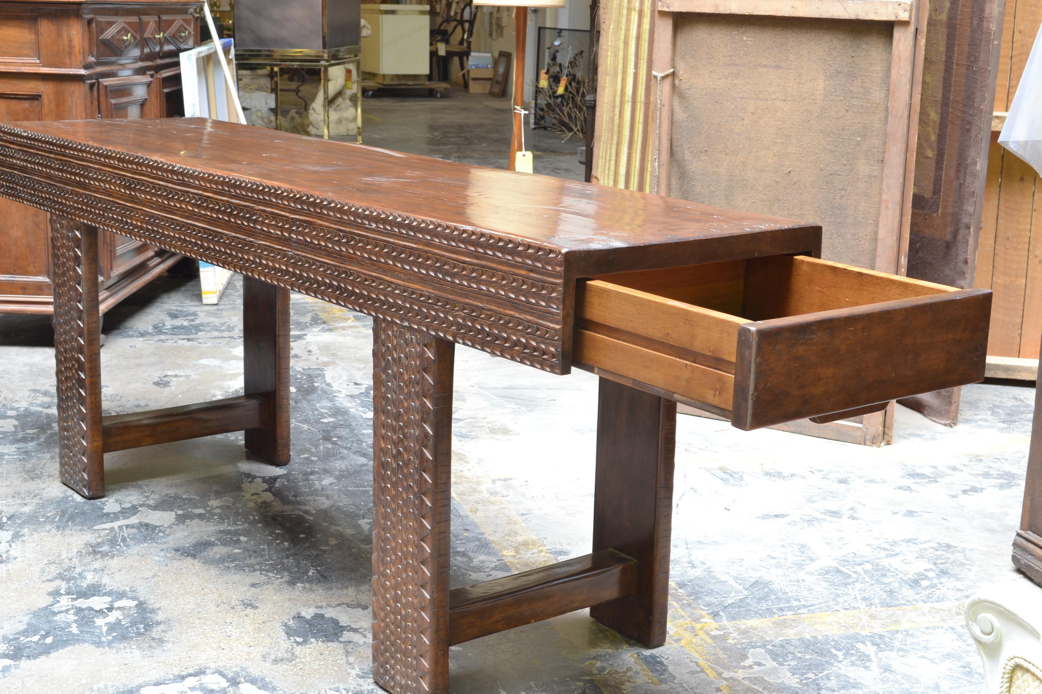 This rustic walnut sofa console has faux distressing with a drawer at each end. Both sides are chip hand carved. 

 