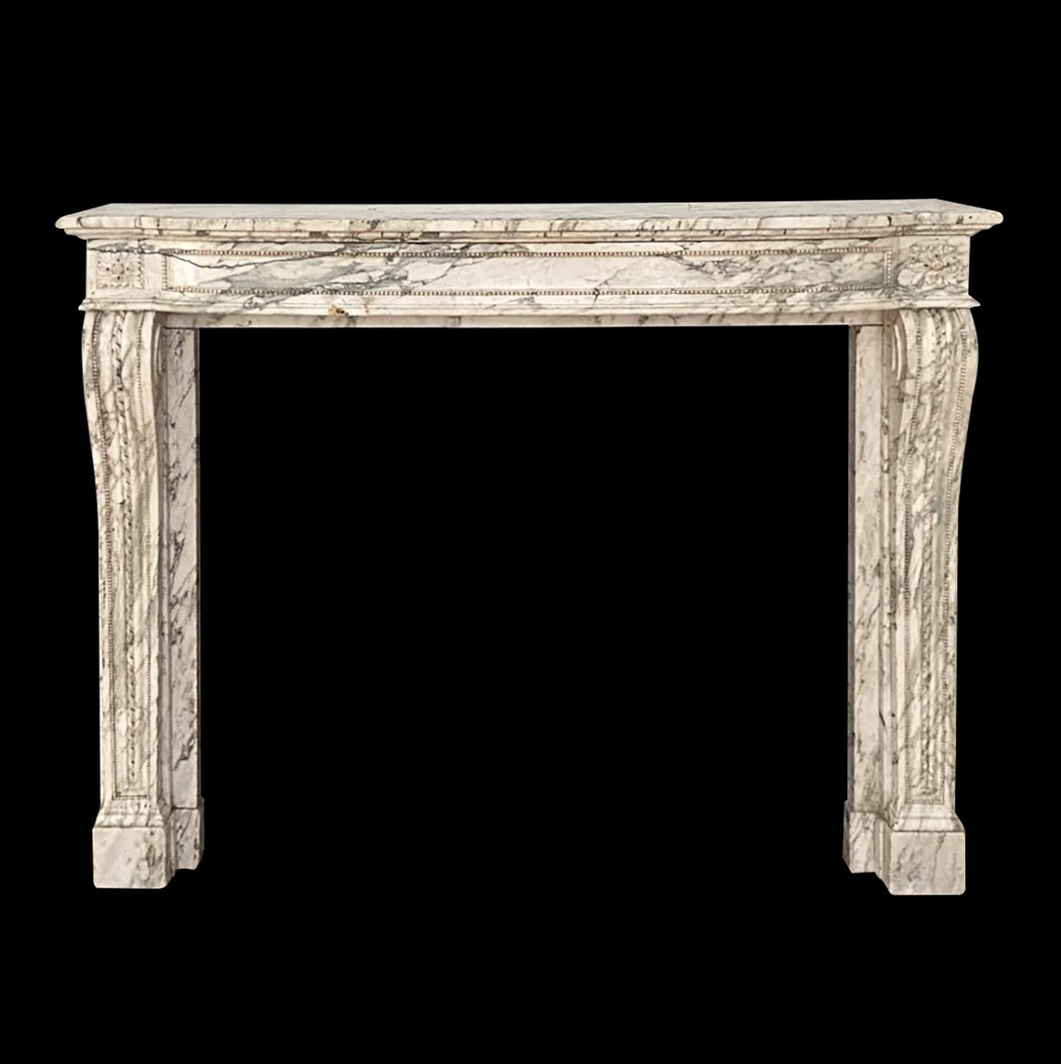 Hand carved white French marble mantel with gray veining. This was retrieved from an estate located in Greenwich, Connecticut. Good condition with appropriate wear from age. One available. Please note, this item is located in one of our NYC