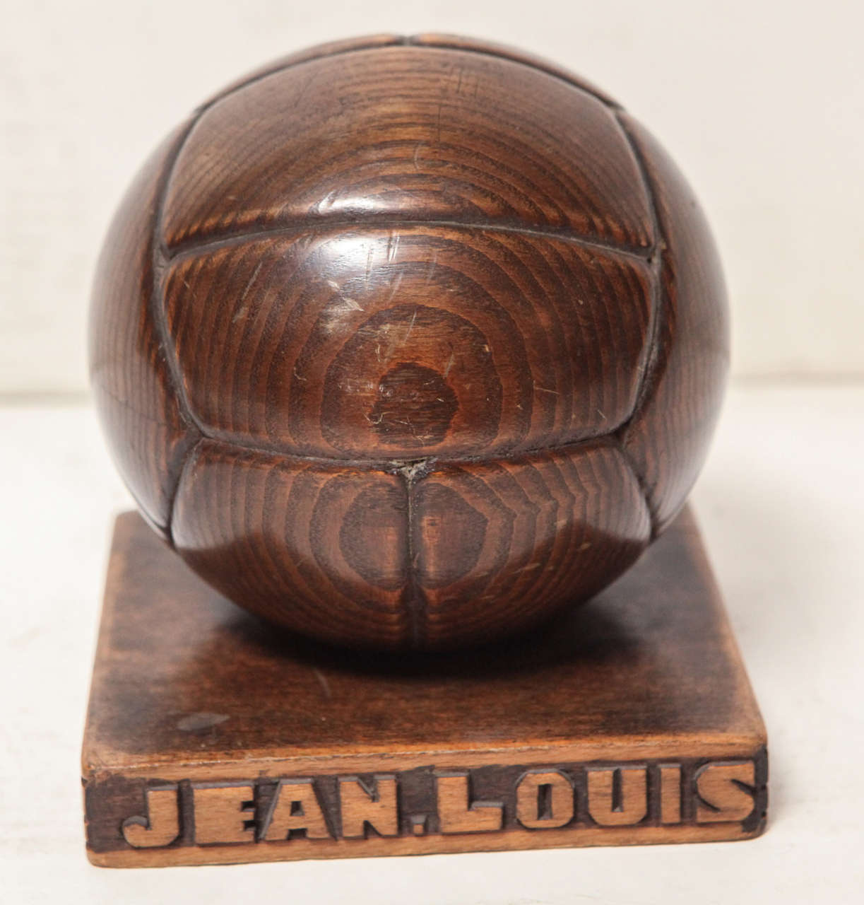 French hand carved wood soccer ball bank. One side of the base is hand carved with the name 
