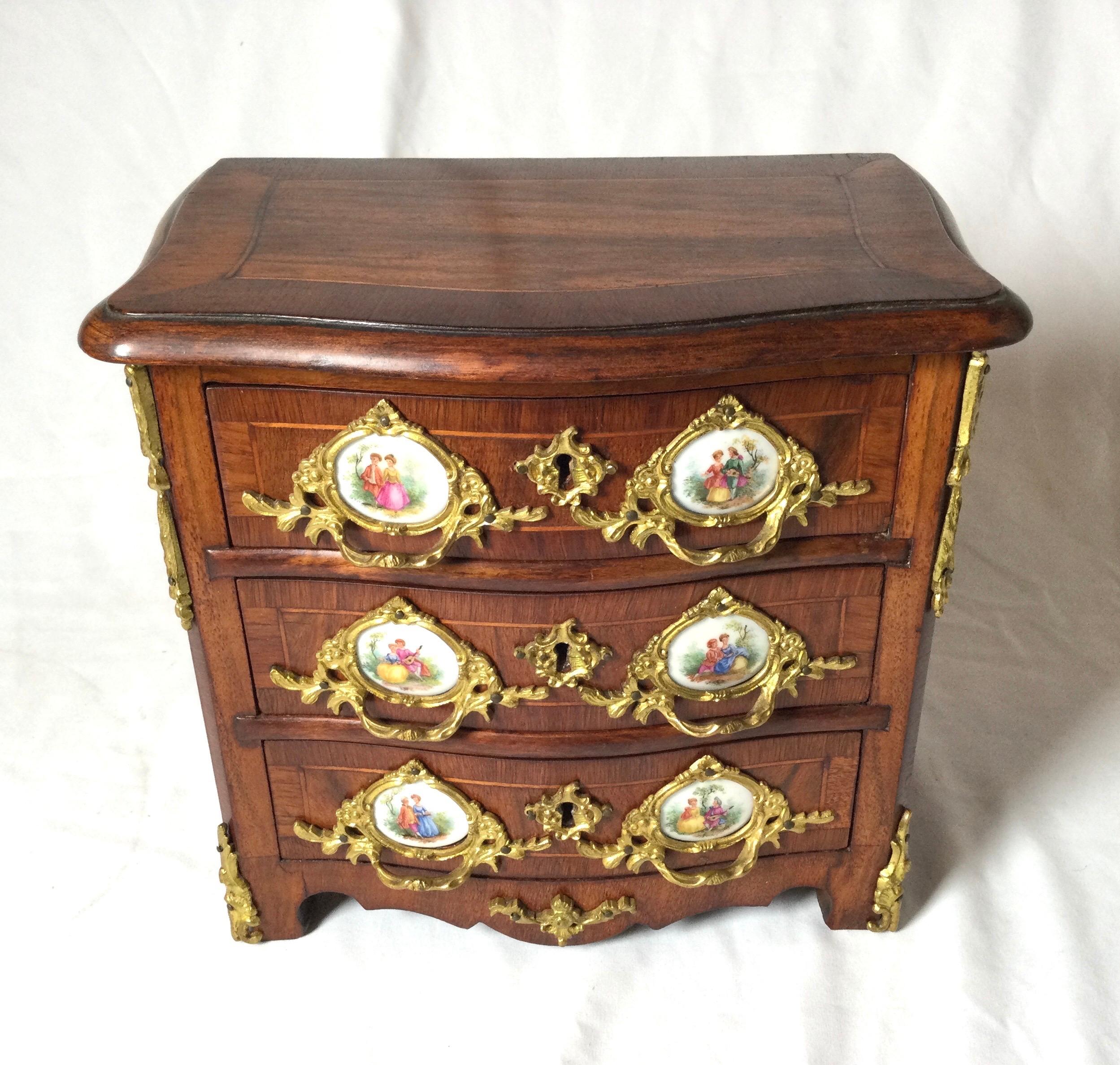 Exquisitely hand crafted late 19th early 20th century antique French jewelry chest. Wood serpentine sides inlay three drawer with porcelain medallions. Key works to open three drawers. Ormolu handles, nice dovetailed drawers. Great size, 10