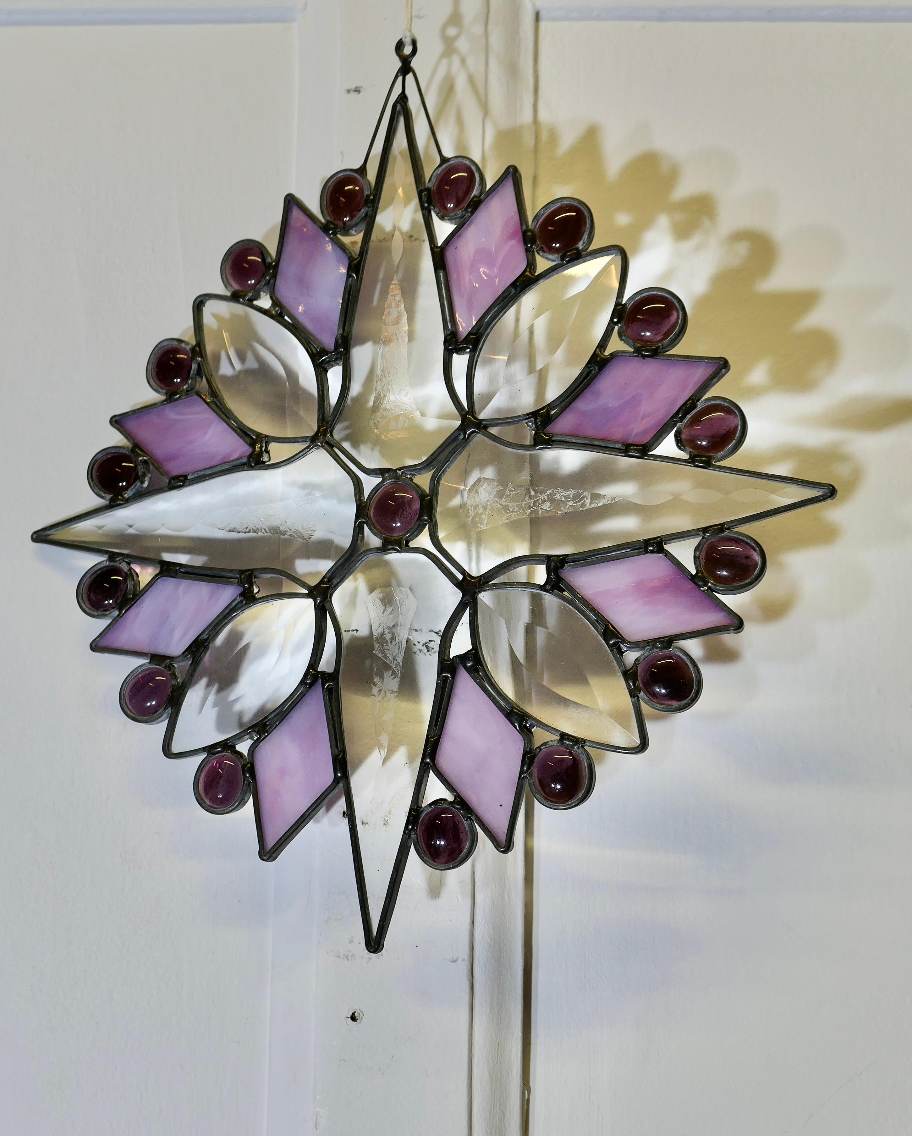 French Hand Made Antique Stained Glass Christmas Window Panel

This lovely Artisan made piece has been made from 19th century jewel crystal and etched and faceted glass, skilfully set to make a star shaped pattern. (Snowflake) This one is in shades