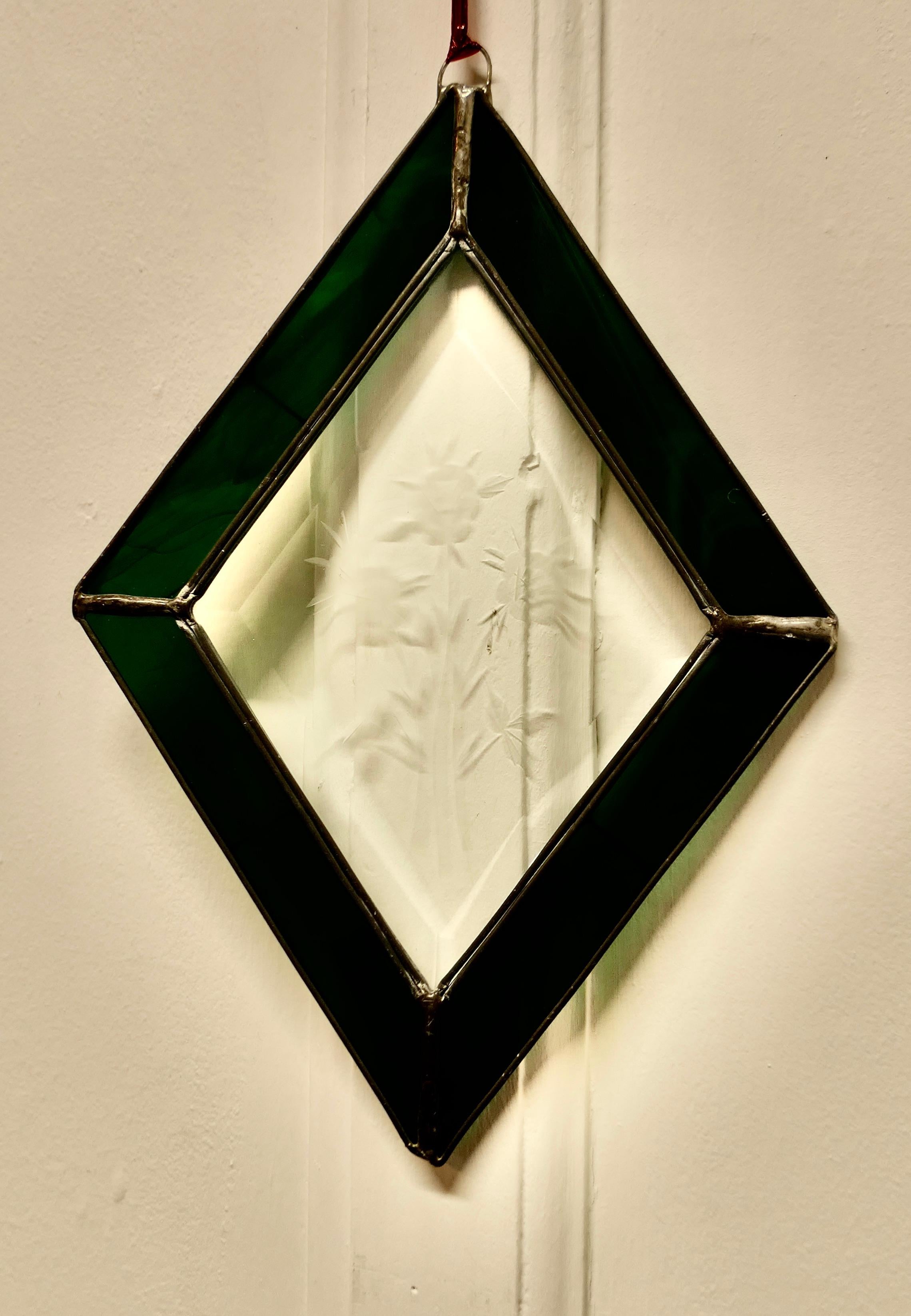 French hand made antique stained glass window panel

This lovely Artisan made piece has been made from 19th century Green Iridescent and Etched Glass, skilfully set to make a Diamond shaped pattern
The Panel is a one off, there is only one like