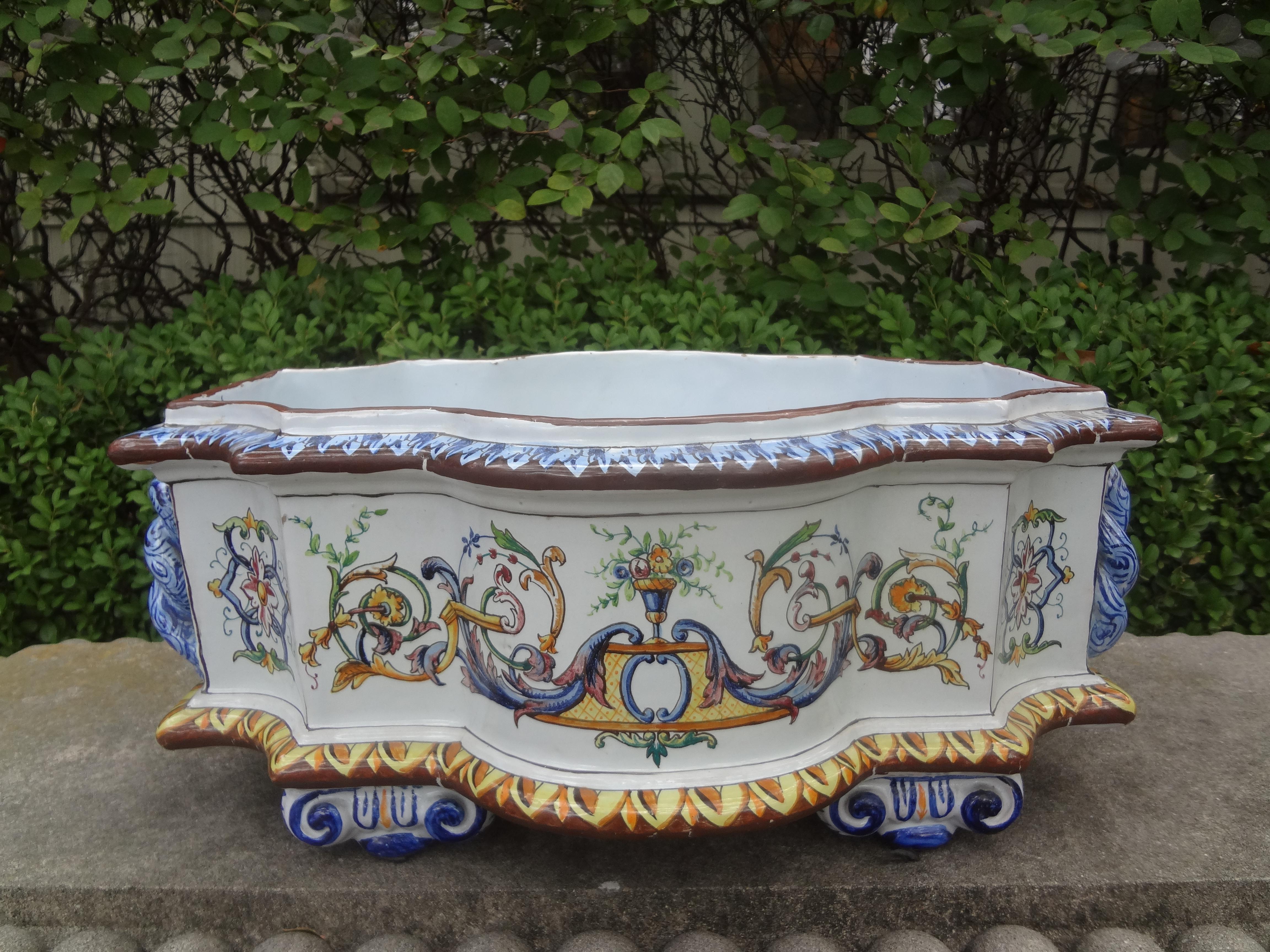 French hand painted faience jardiniere or cachepot. 
This beautiful hand decorated French faience planter, jardiniere or cachepot is the perfect centerpiece for a dining table, coffee table or kitchen. In the style of Gien, Quimper, Nevers and