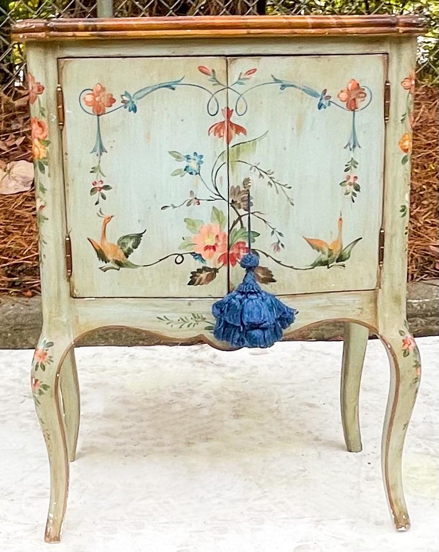 This is a lovely piece. It is a hand painted French petite commode with a faux marble top. Even the interiors of the drawers are painted! it does include a key.