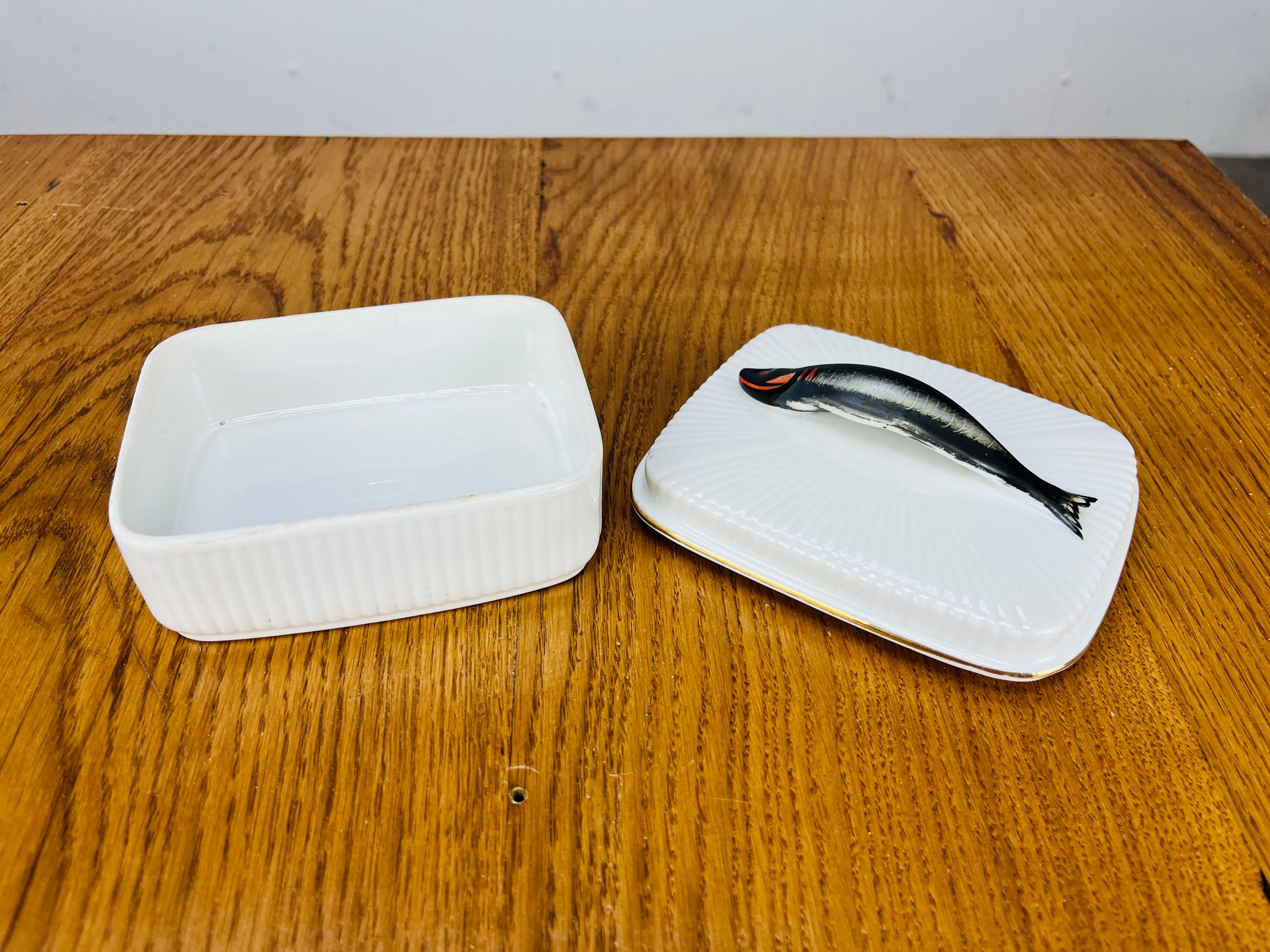 Sardinendose aus französischem Porzellan, mit goldenem Futter am Rand des Deckels und einer handgemalten Sardine als Griff. Es ist in perfektem Zustand. Sie trägt die Stempel 